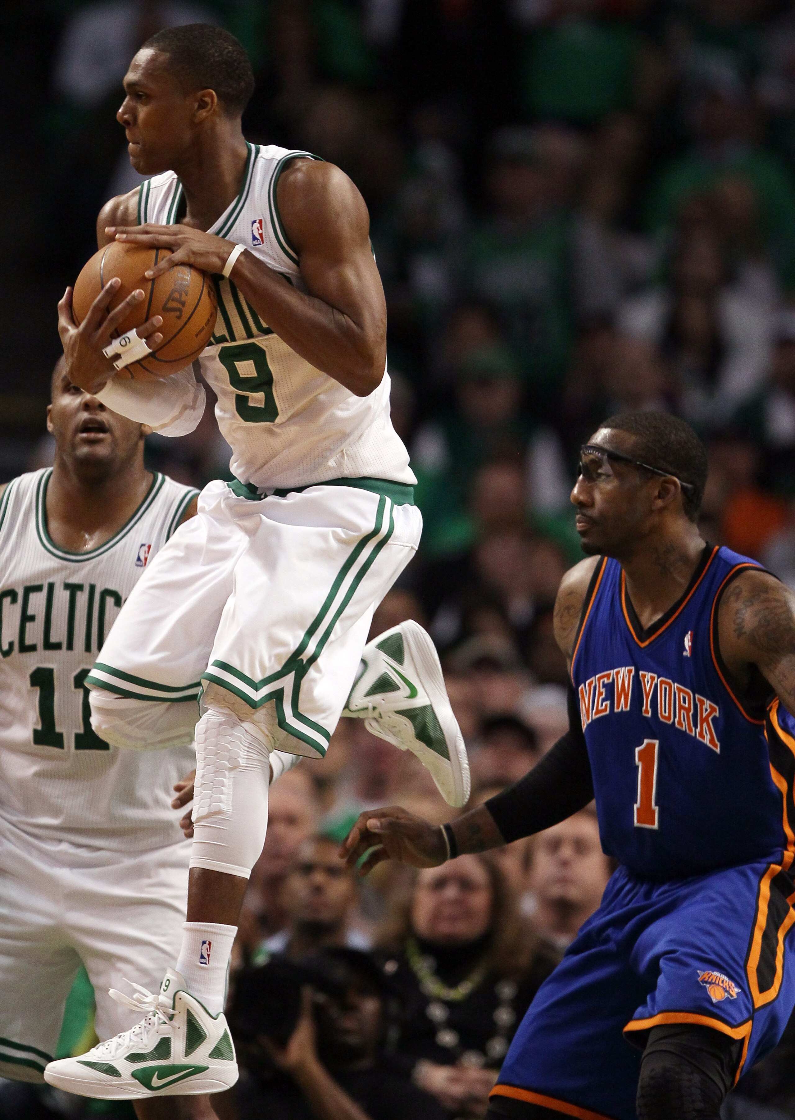 BOSTON, MA - APRIL 17:  Rajon Rondo #9 of the Boston Celtics grabs the ball as Amare Stoudemire #1 of the New York Knicks defends in Game One of the Eastern Conference Quarterfinals in the 2011 NBA Playoffs on April 17, 2011 at the TD Garden in Boston, Ma