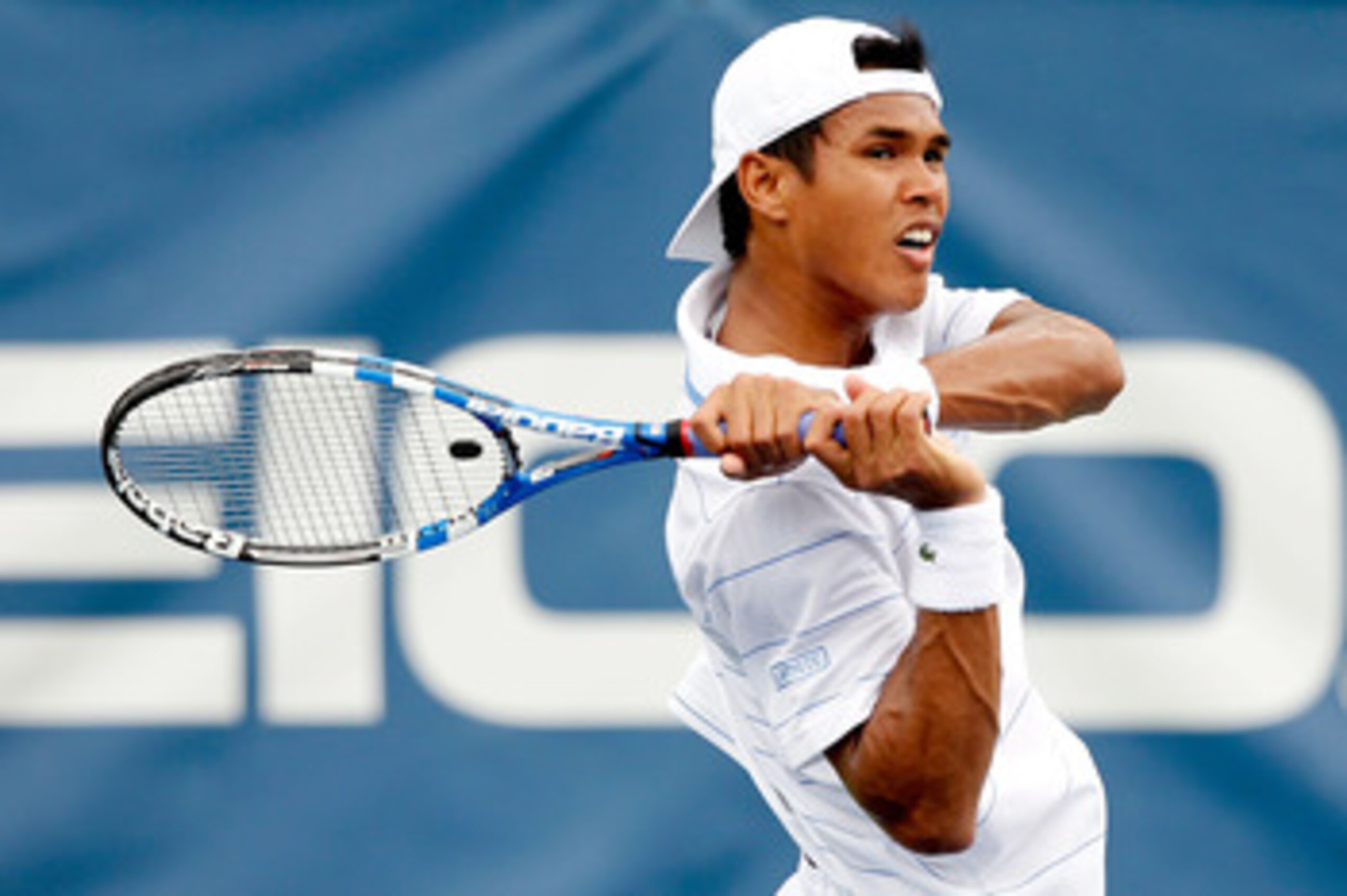 WASHINGTON, DC - AUGUST 04: Somdev Devvarman of India returns a shot to Marcos Baghdatis of Cyprus during the Legg Mason Tennis Classic presented by Geico at the William H.G. FitzGerald Tennis Center on August 4, 2011 in Washington, DC.  (Photo by Matthew