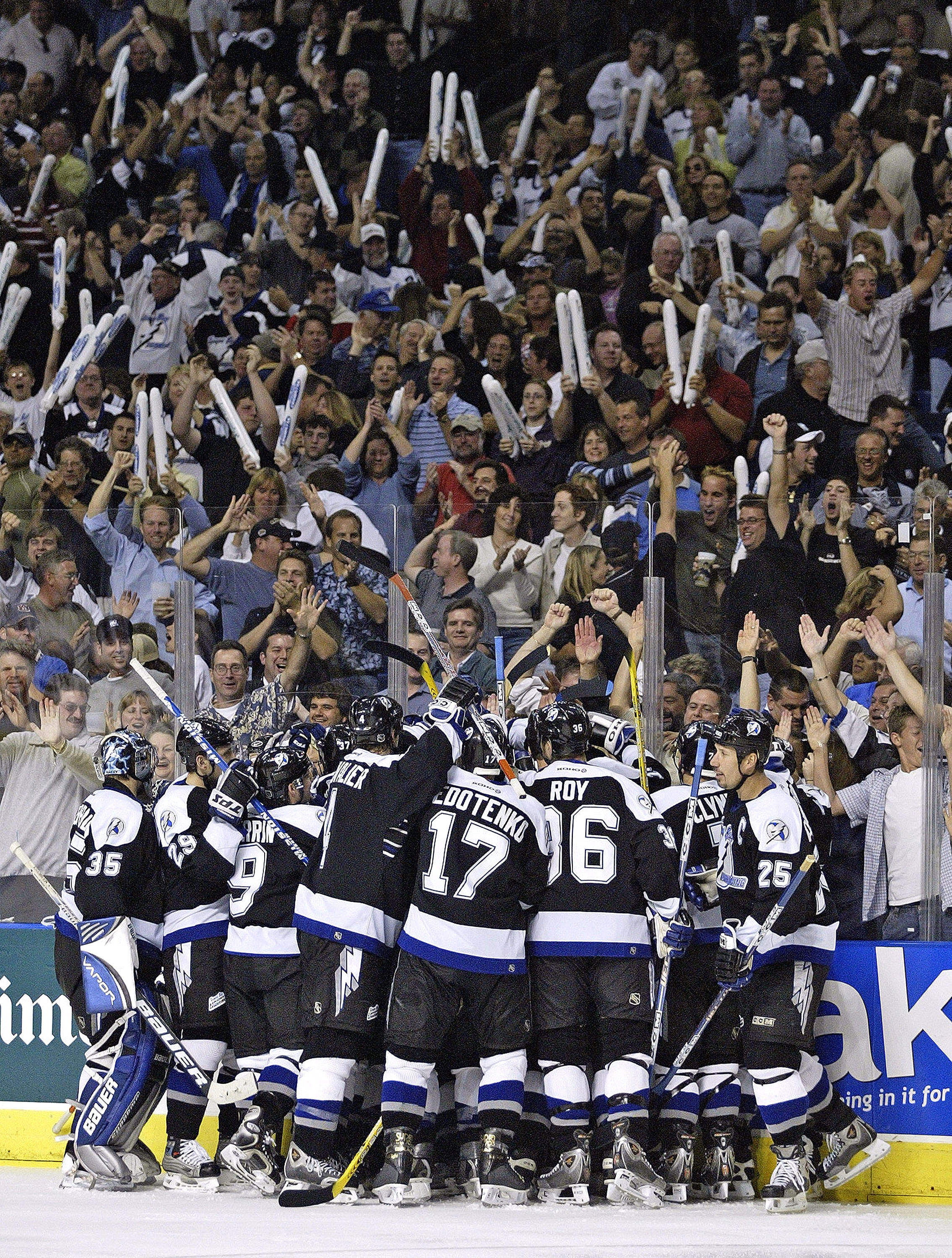 TAMPA, FL - APRIL 16:  The Tampa Bay Lightning crowd around teammate Martin St. Louis and celebrate his winning goal after defeating the New York Islanders 3-2 in overtime in the first round of the Stanley Cup Playoffs on April 16, 2004 at the St. Petersb