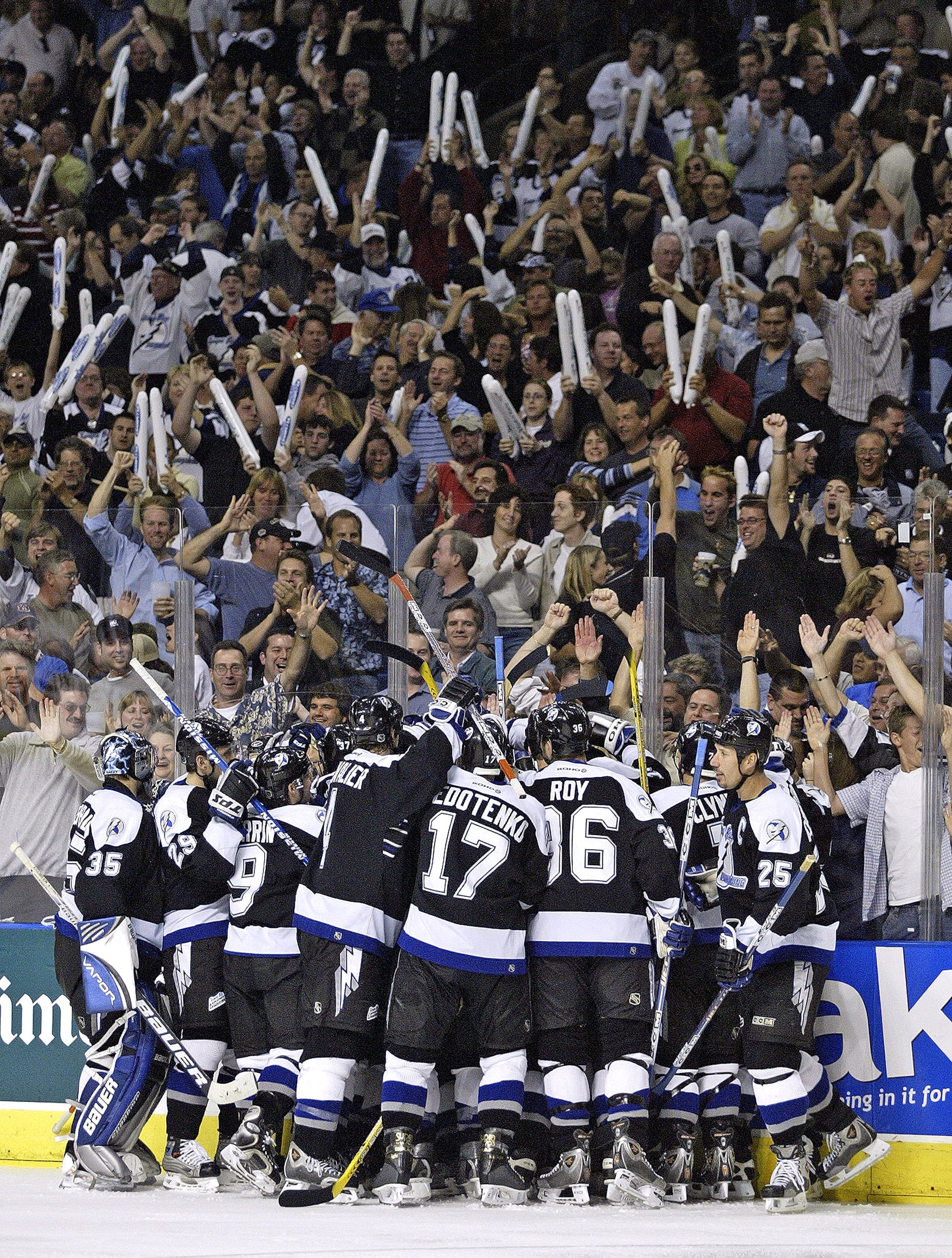 TAMPA, FL - APRIL 16:  The Tampa Bay Lightning crowd around teammate Martin St. Louis and celebrate his winning goal after defeating the New York Islanders 3-2 in overtime in the first round of the Stanley Cup Playoffs on April 16, 2004 at the St. Petersb