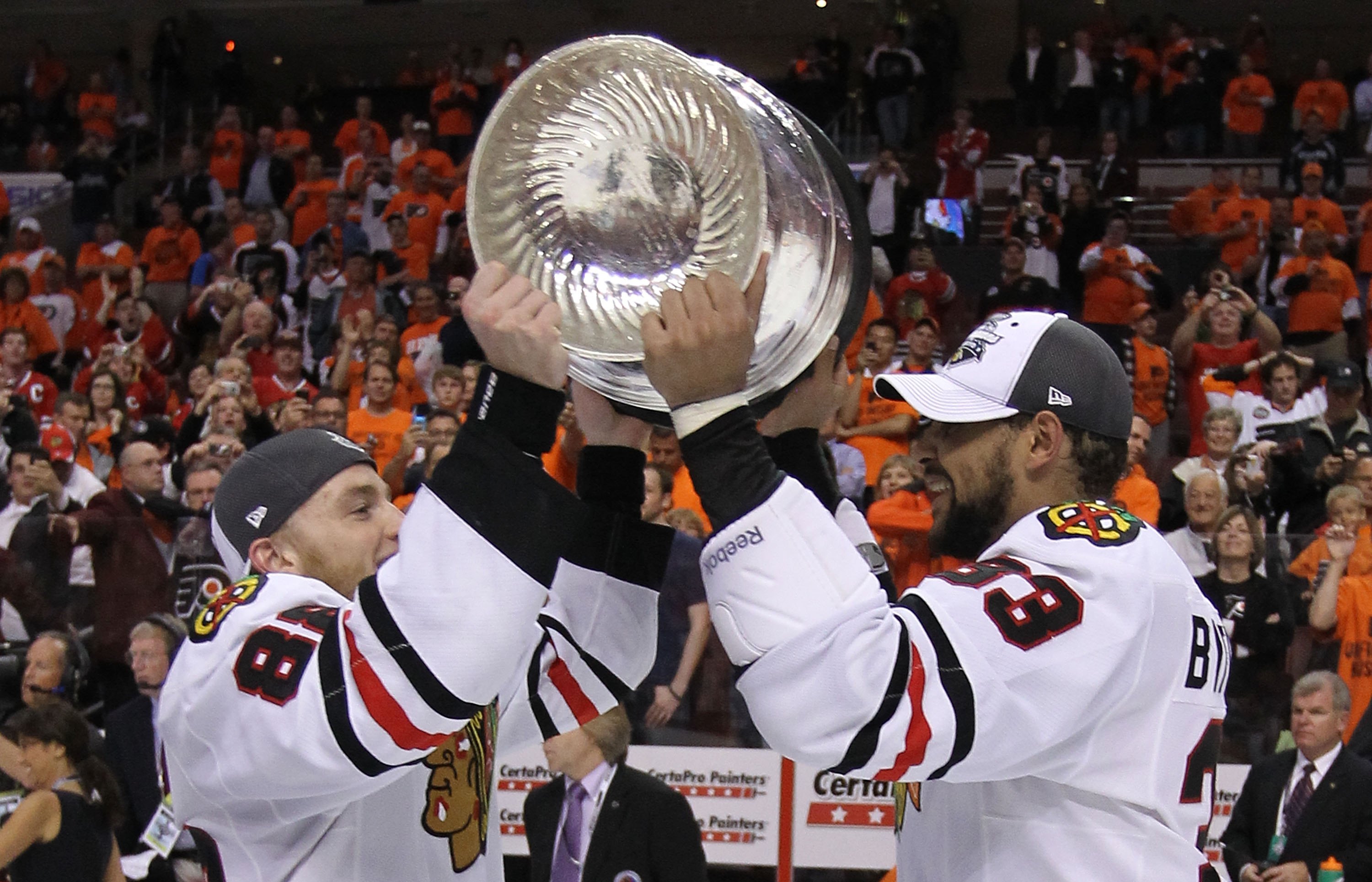 PHILADELPHIA - JUNE 09: Patrick Kane #88 and Dustin Byfuglien #33 of the Chicago Blackhawks share the Stanley Cup after the Blackhawks defeated the Philadelphia Flyers 4-3 in overtime to win the Stanley Cup in Game Six of the 2010 NHL Stanley Cup Final at