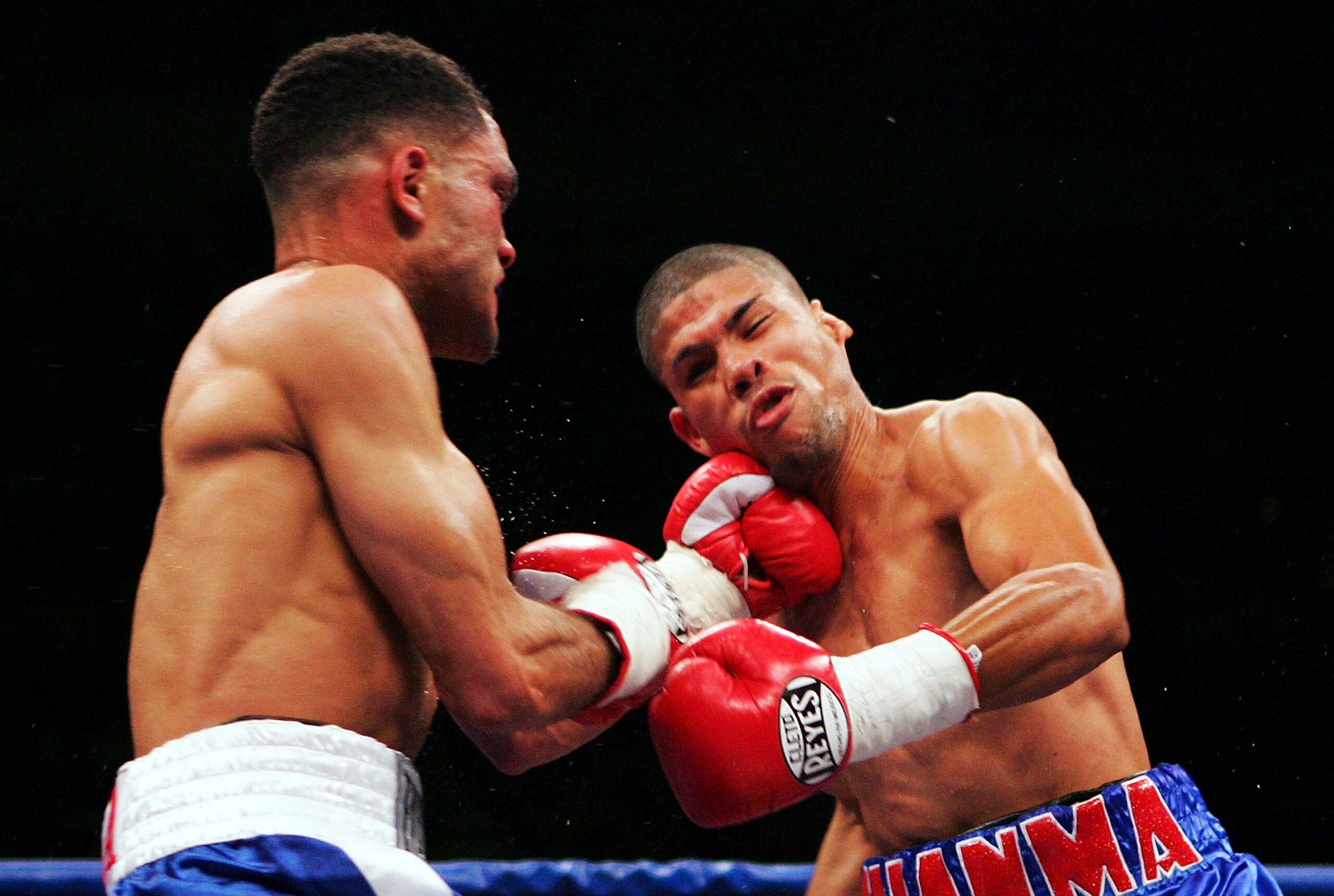 SAN JUAN, PUERTO RICO - MARCH 03:  Juan Manuel Lopez (R) receives a punch from Juan Brea during their fight on March 3, 2007 at the Roberto Clemente Coliseo in San Juan, Puerto Rico.  (Photo by Al Bello/Getty Images)