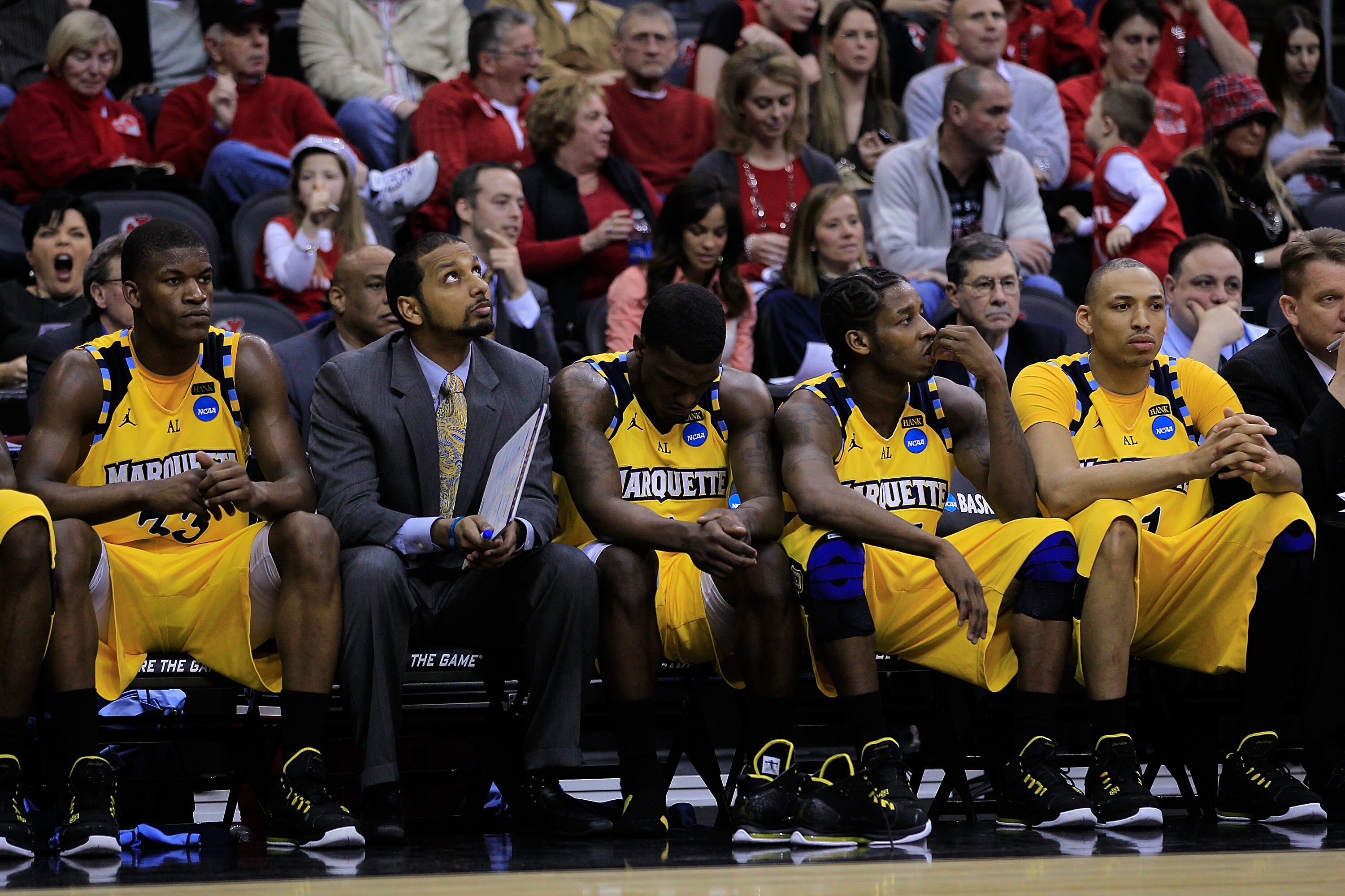 NEWARK, NJ - MARCH 25:  Jimmy Butler #33 of the Marquette Golden Eagles sits with his teammates on the bench during the game against the North Carolina Tar Heels in the east regional semifinal of the 2011 NCAA Men's Basketball Tournament at the Prudential