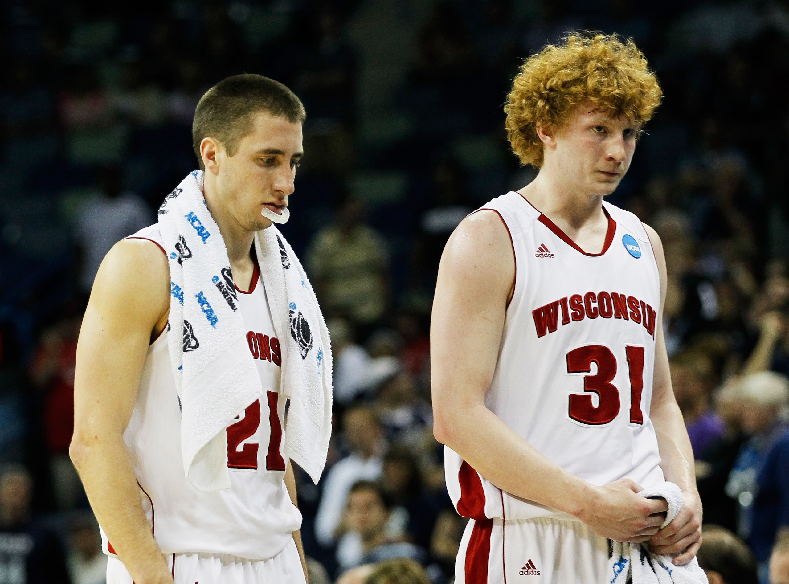 NEW ORLEANS, LA - MARCH 24:  Josh Gasser #21 and Mike Bruesewitz #31 of the Wisconsin Badgers react after their 54 to 61 loss to the Butler Bulldogs during the Southeast regional of the 2011 NCAA men's basketball tournament at New Orleans Arena on March 2