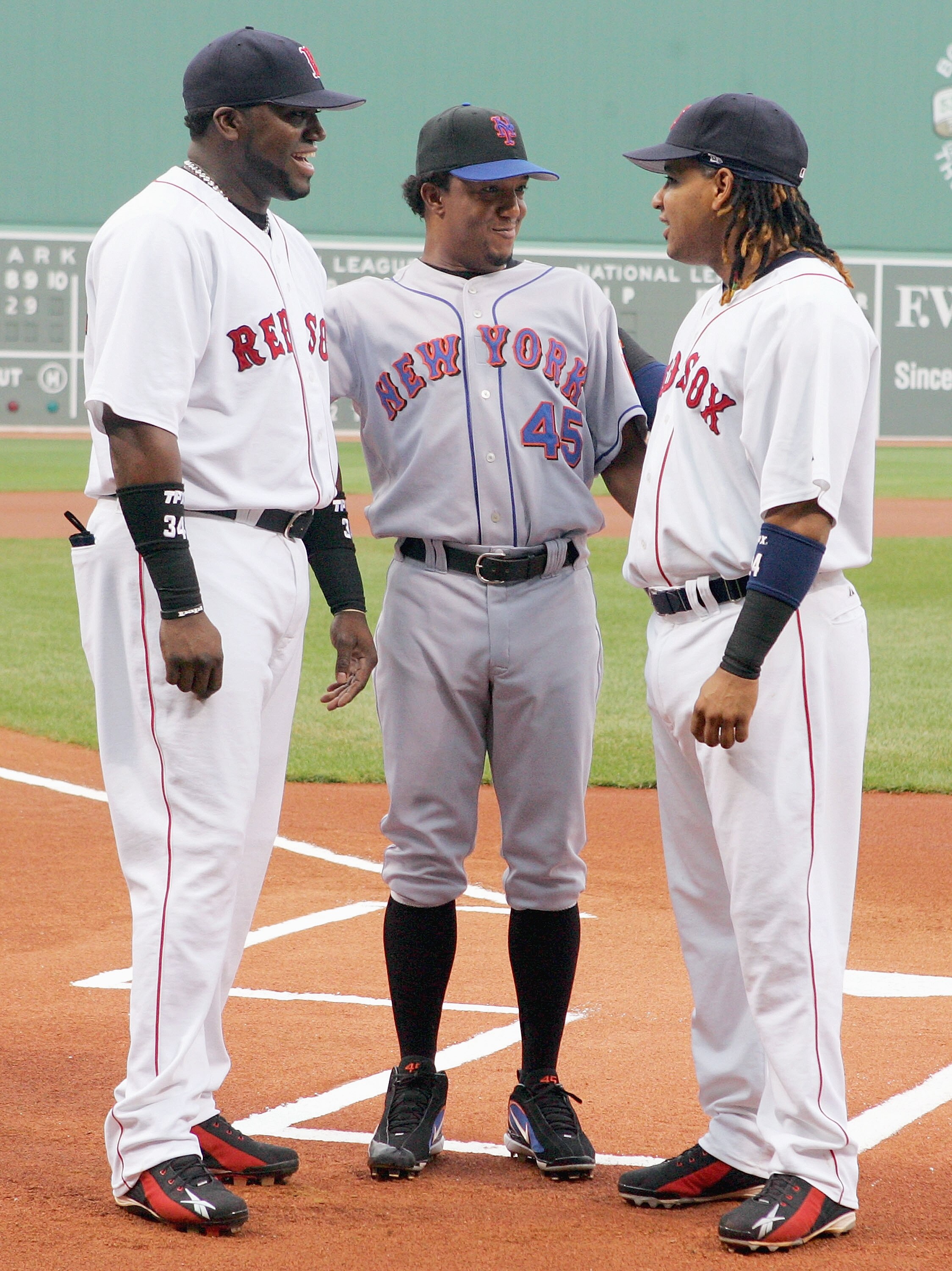 BOSTON - JUNE 29: David Ortiz #34 (L) and Manny Ramirez #24 of the Boston Red Sox talk with former teammate Pedro Martinez #45 of the New York Mets before their game on June 29, 2006 at Fenway Park in Boston, Massachusetts. (Photo by Jim McIsaac/Getty Ima