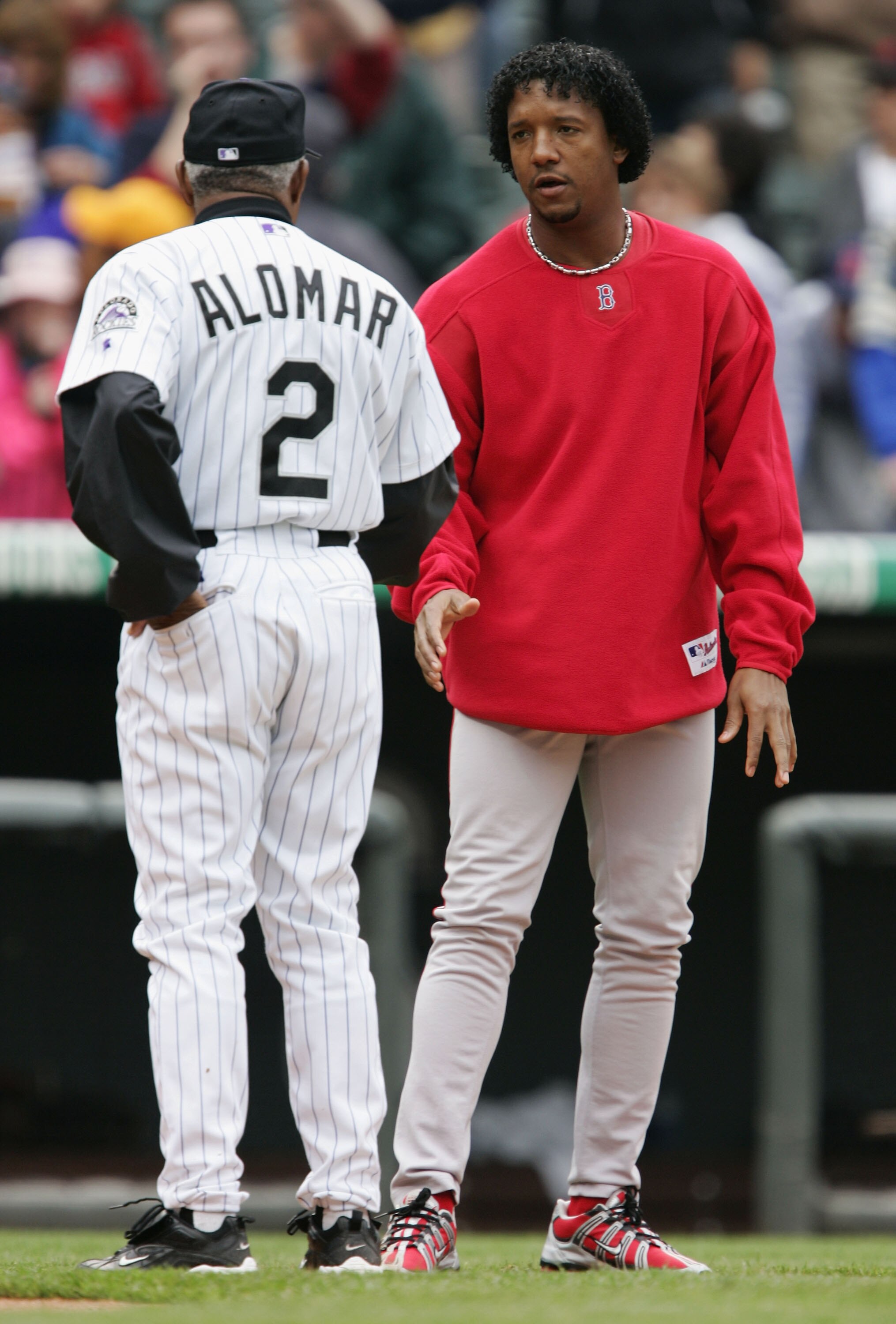 DENVER - JUNE 17:  Pedro Martinez of the Boston Red Sox stops to greet Sandy Alomar #2 of the Colorado Rockies after their game June 17, 2004 at Coors Field in Denver, Colorado. The Red Sox won 11-0.  (Photo by Brian Bahr/Getty Images)
