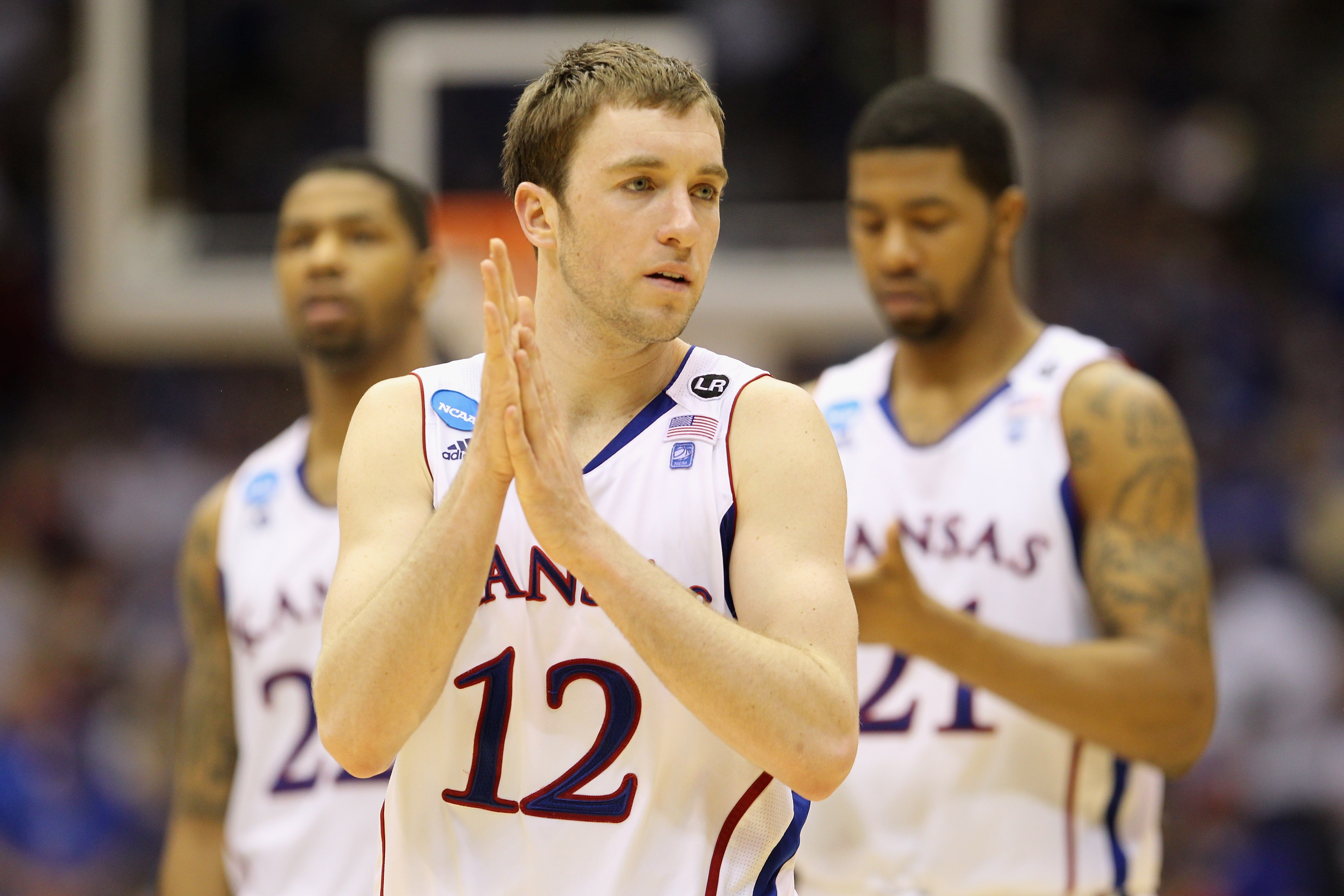 SAN ANTONIO, TX - MARCH 27:  Brady Morningstar #12, Marcus Morris #22 and Markieff Morris #21 of the Kansas Jayhawks react during the southwest regional final of the 2011 NCAA men's basketball tournament against the Virginia Commonwealth Rams at the Alamo