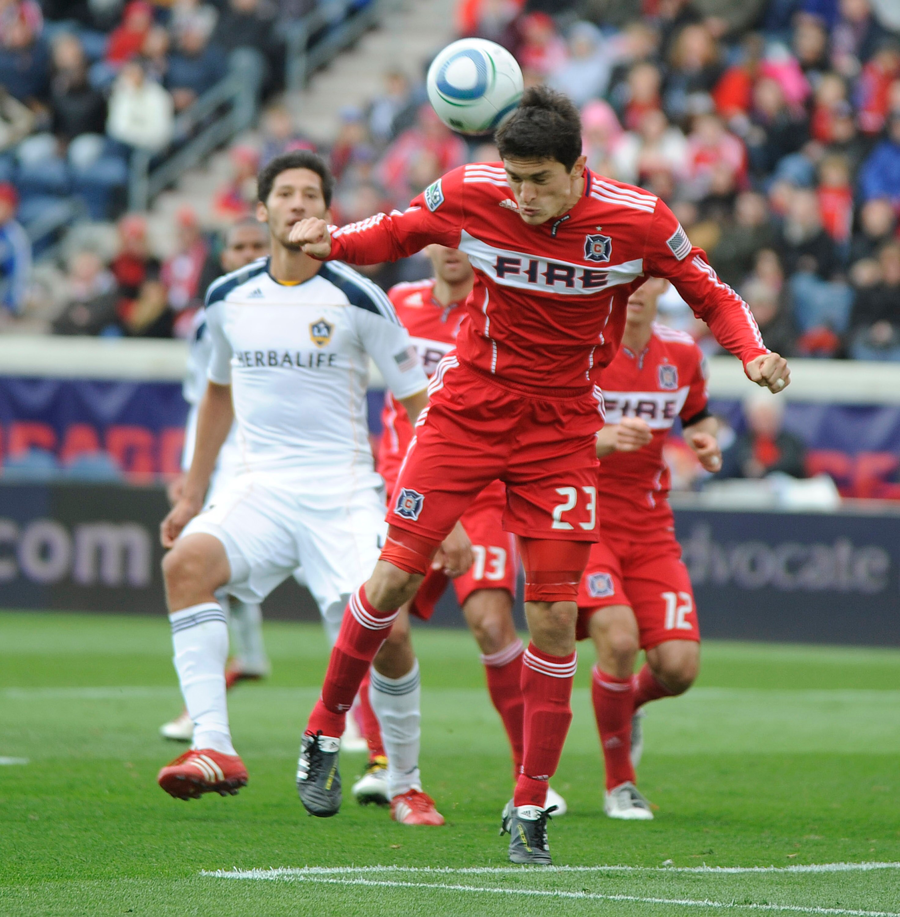 BRIDGEVIEW, IL - APRIL 17: Omar Gonzalez #4 of the Los Angeles Galaxy and Josip Mikulic #23 of the Chicago Fire go for the ball in an MLS match on April 17, 2011 at Toyota Park in Bridgeview, Illinois. The Galaxy won 2-1. (Photo by David Banks/Getty Image