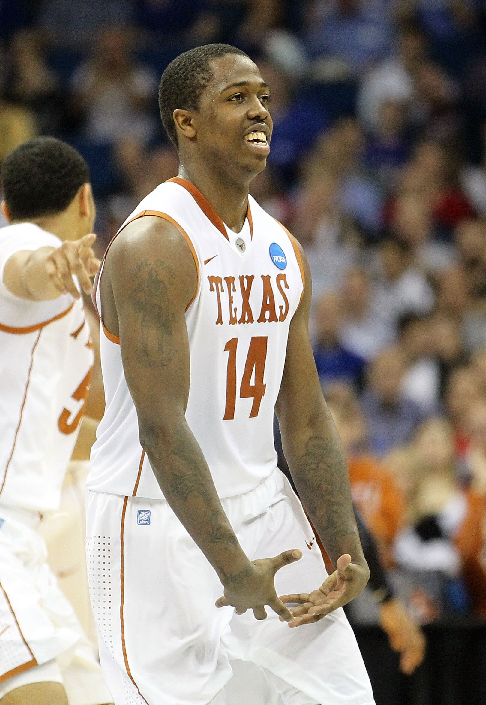 TULSA, OK - MARCH 20:  J'Covan Brown #14 of the Texas Longhorns reacts to a play against the Arizona Wildcats during the third round of the 2011 NCAA men's basketball tournament at BOK Center on March 20, 2011 in Tulsa, Oklahoma.  (Photo by Ronald Martine