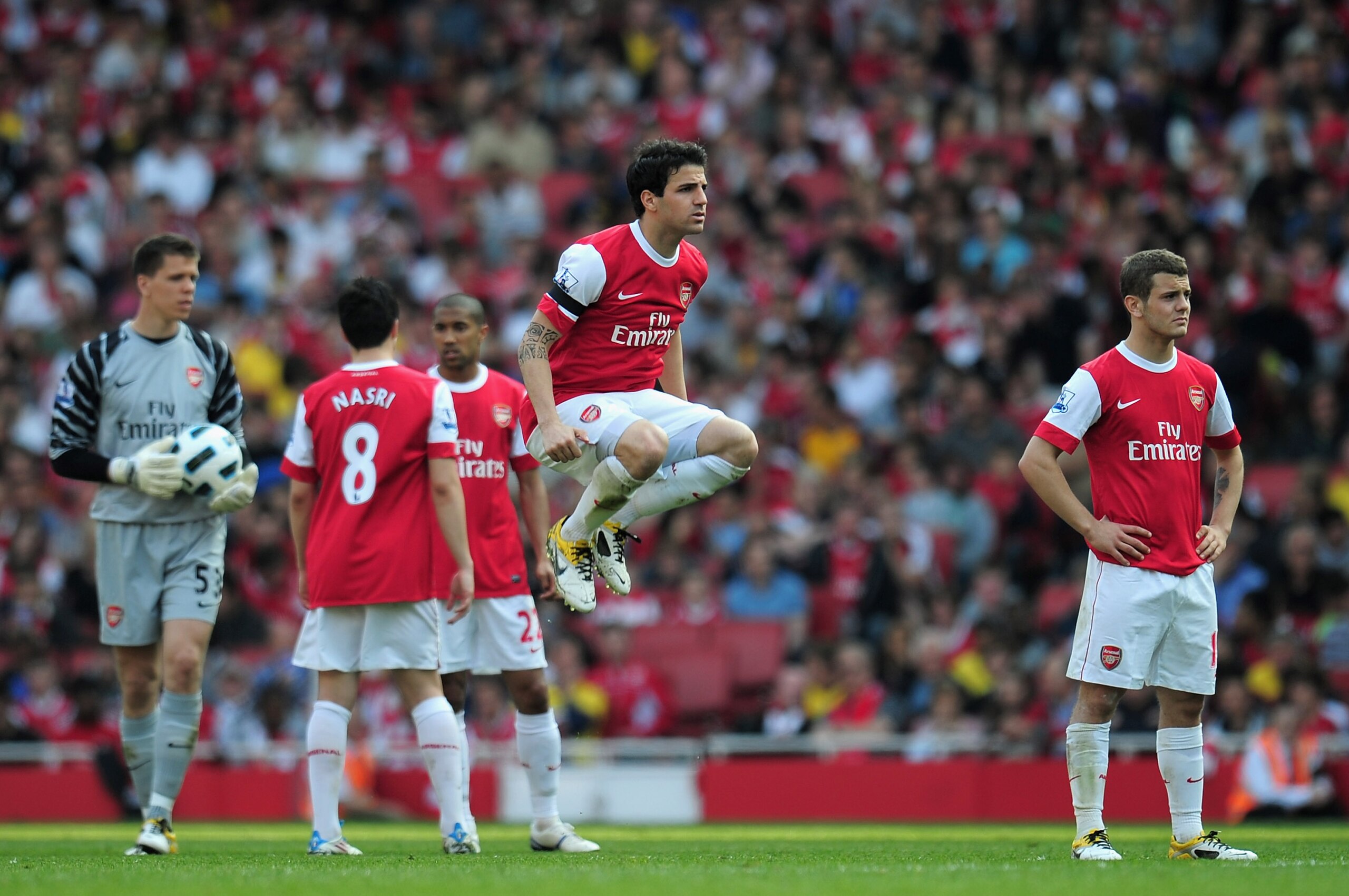 LONDON, ENGLAND - APRIL 17: Cesc Fabregas of Arsenal jumps while his team wait for medical staff to access the injury to Jamie Carragher of Liverpool during the Barclays Premier League match between Arsenal and Liverpool at the Emirates Stadium on April LONDON, ENGLAND - APRIL 17: Cesc Fabregas of Arsenal jumps while his team wait for medical staff to access the injury to Jamie Carragher of Liverpool during the Barclays Premier League match between Arsenal and Liverpool at the Emirates Stadium on April