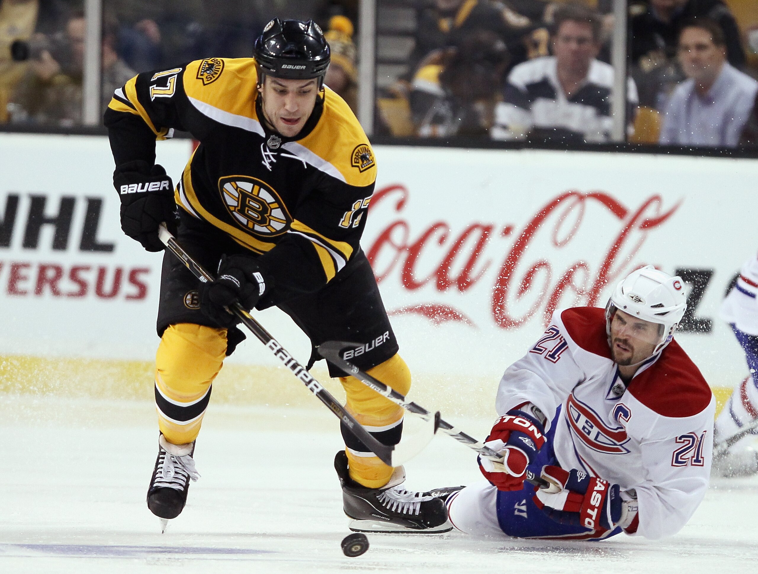 BOSTON, MA - APRIL 14:  Milan Lucic #17 of the Boston Bruins steals the puck from Brian Gionta #21 of the Montreal Canadiens in Game One of the Eastern Conference Quarterfinals during the 2011 NHL Stanley Cup Playoffs at TD Garden on April 14, 2011 in Bos