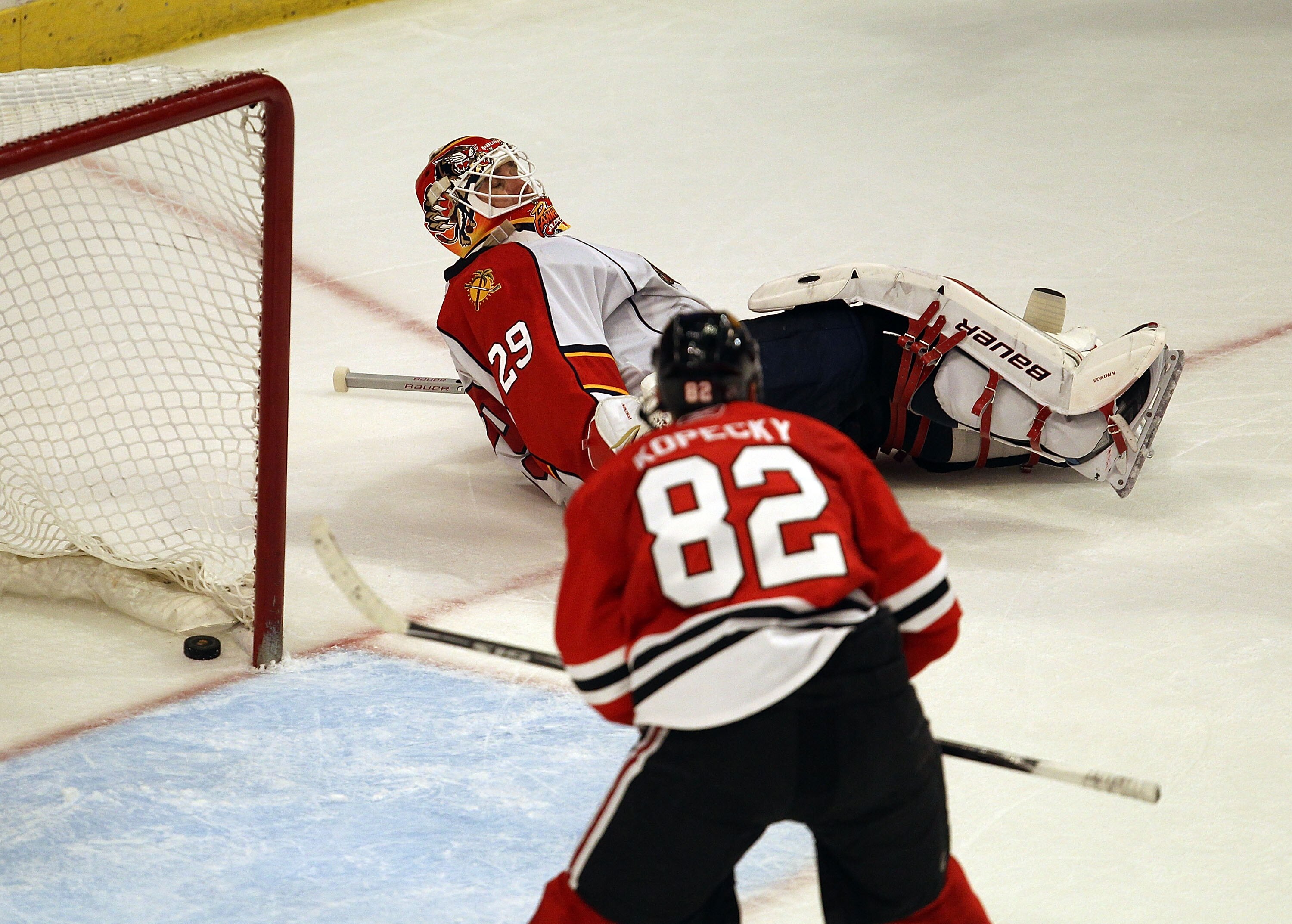 CHICAGO, IL - MARCH 23: Tomas Kopecky #82 of the Chicago Blackhawks watches the puck go into the net as Tomas Vokoun #29 of the Florida Panthers lays on the ice out of the crease at the United Center on March 23, 2011 in Chicago, Illinois. The Blackhawks