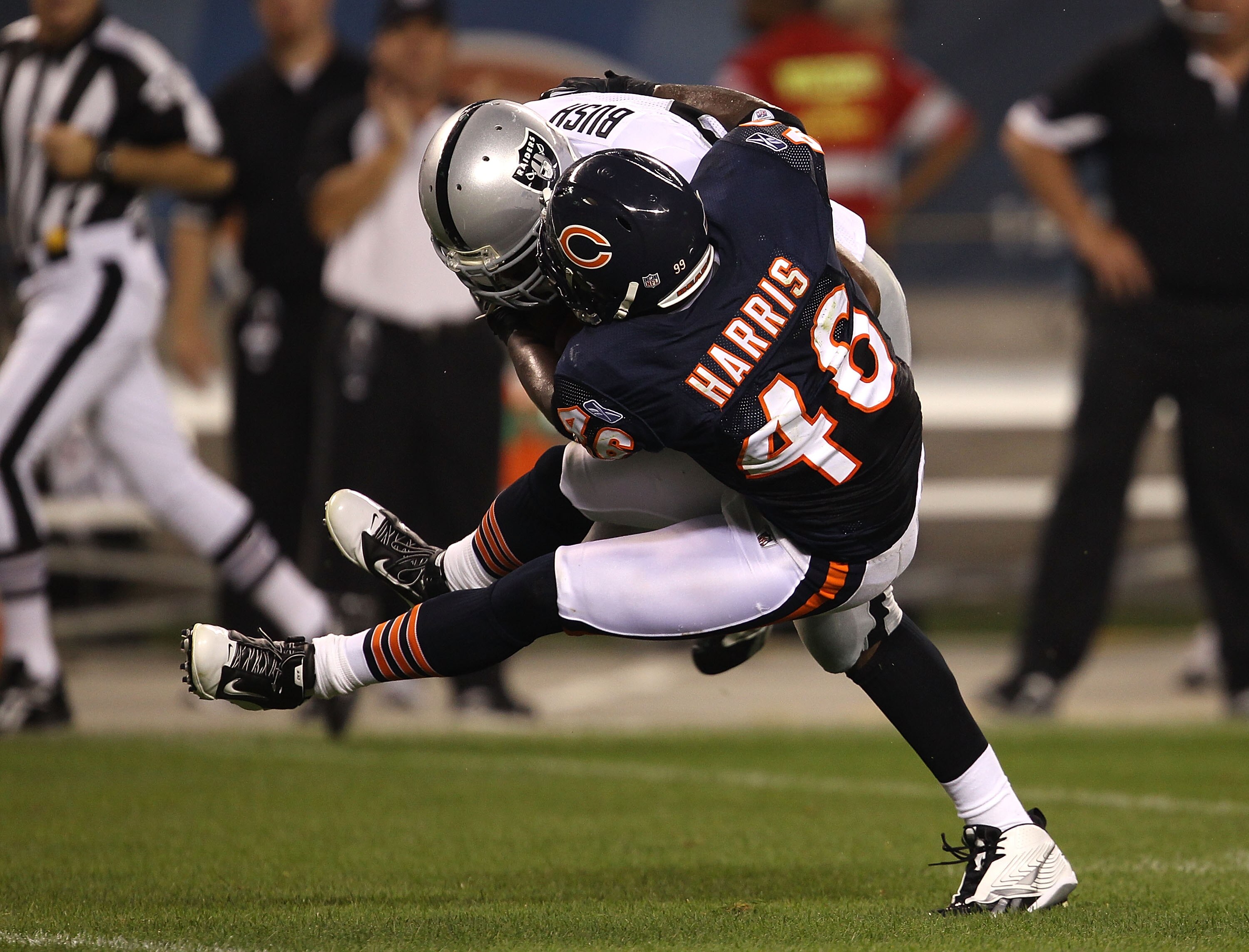 CHICAGO - AUGUST 21: Chris Harris #46 of the Chicago Bears goes airbourne to tackle Michael Bush #29 of the Oakland Raiders during a preseason game at Soldier Field on August 21, 2010 in Chicago, Illinois. The Raiders defeated the Bears 32-17. (Photo by J