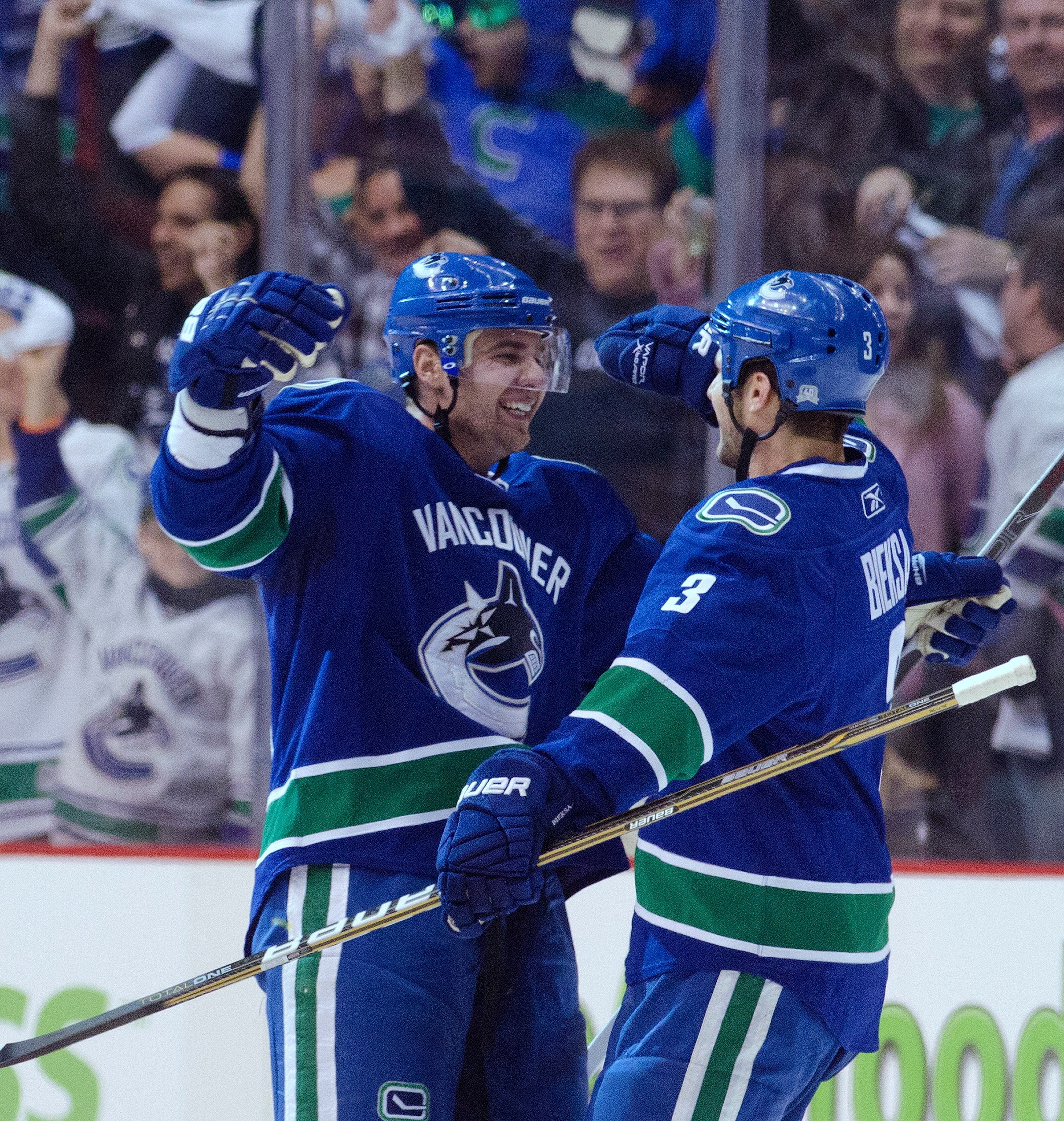 VANCOUVER, CANADA - APRIL 13: Chris Higgins #20 of the Vancouver Canucks celebrates with Kevin Bieksa #3 after scoring against the Chicago Blackhawks during the first period in Game One of the Western Conference Quarterfinals during the 2011 NHL Stanley C