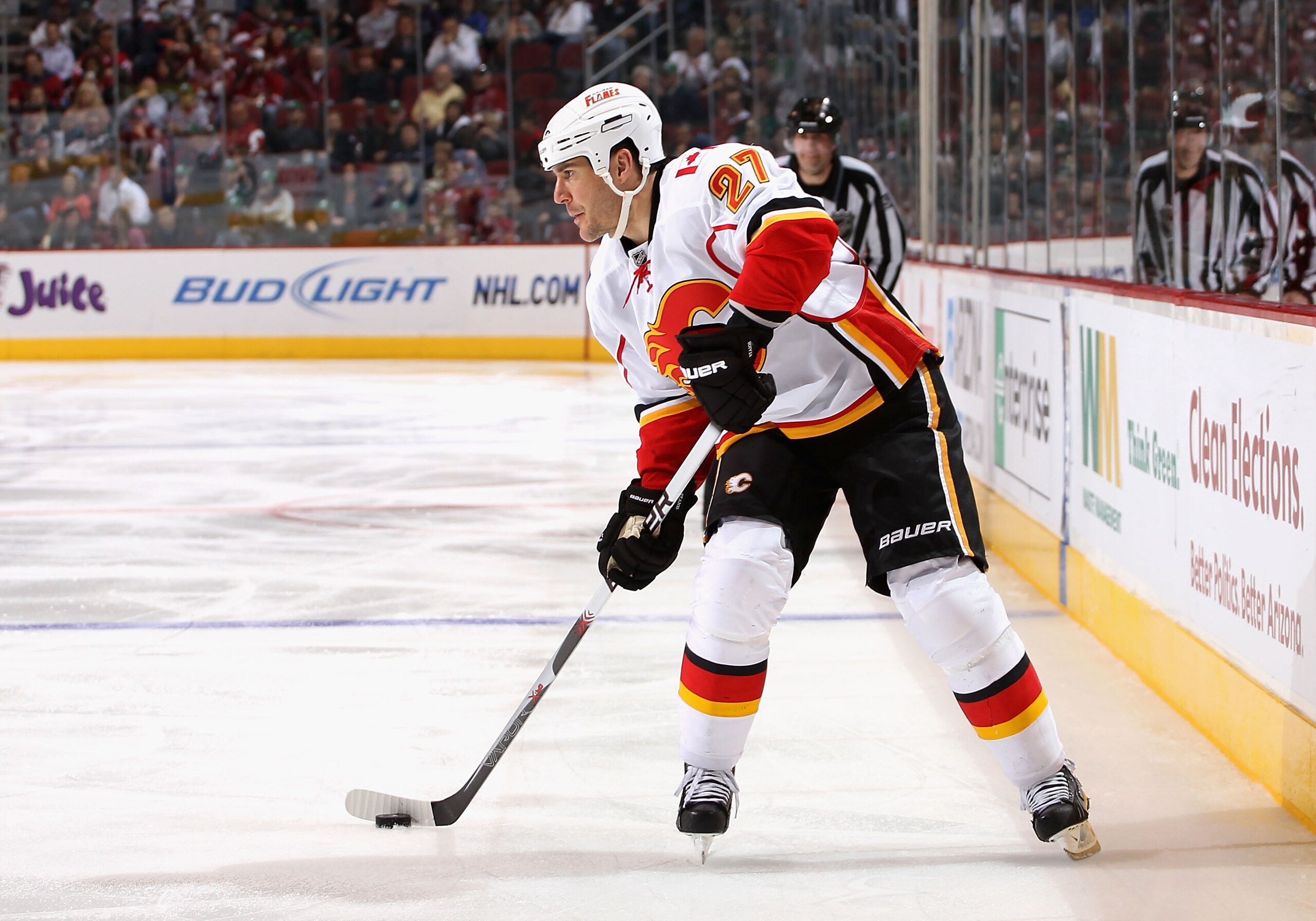 GLENDALE, AZ - MARCH 10:  Steve Staios #27 of the Calgary Flames skates with the puck during the NHL game against the Phoenix Coyotes at Jobing.com Arena on March 10, 2011 in Glendale, Arizona.  The Coyotes defeated the Flames 3-0.  (Photo by Christian Pe