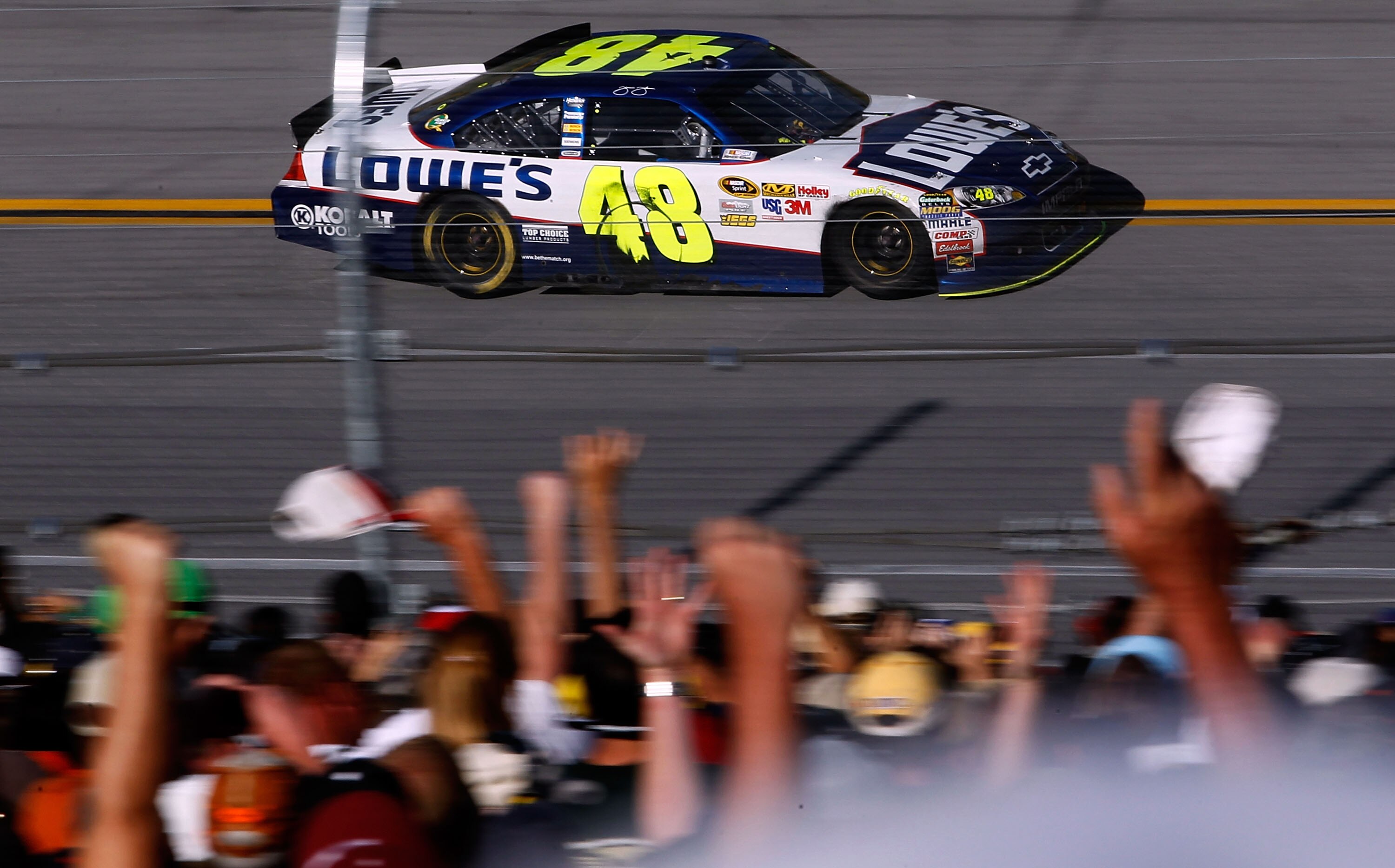 TALLADEGA, AL - APRIL 17: Jimmie Johnson, driver of the #48 Lowe's Chevrolet, takes a victory lap, as fans cheer, after winning the NASCAR Sprint Cup Series Aaron's 499 at Talladega Superspeedway on April 17, 2011 in Talladega, Alabama.  (Photo by Tom Pen