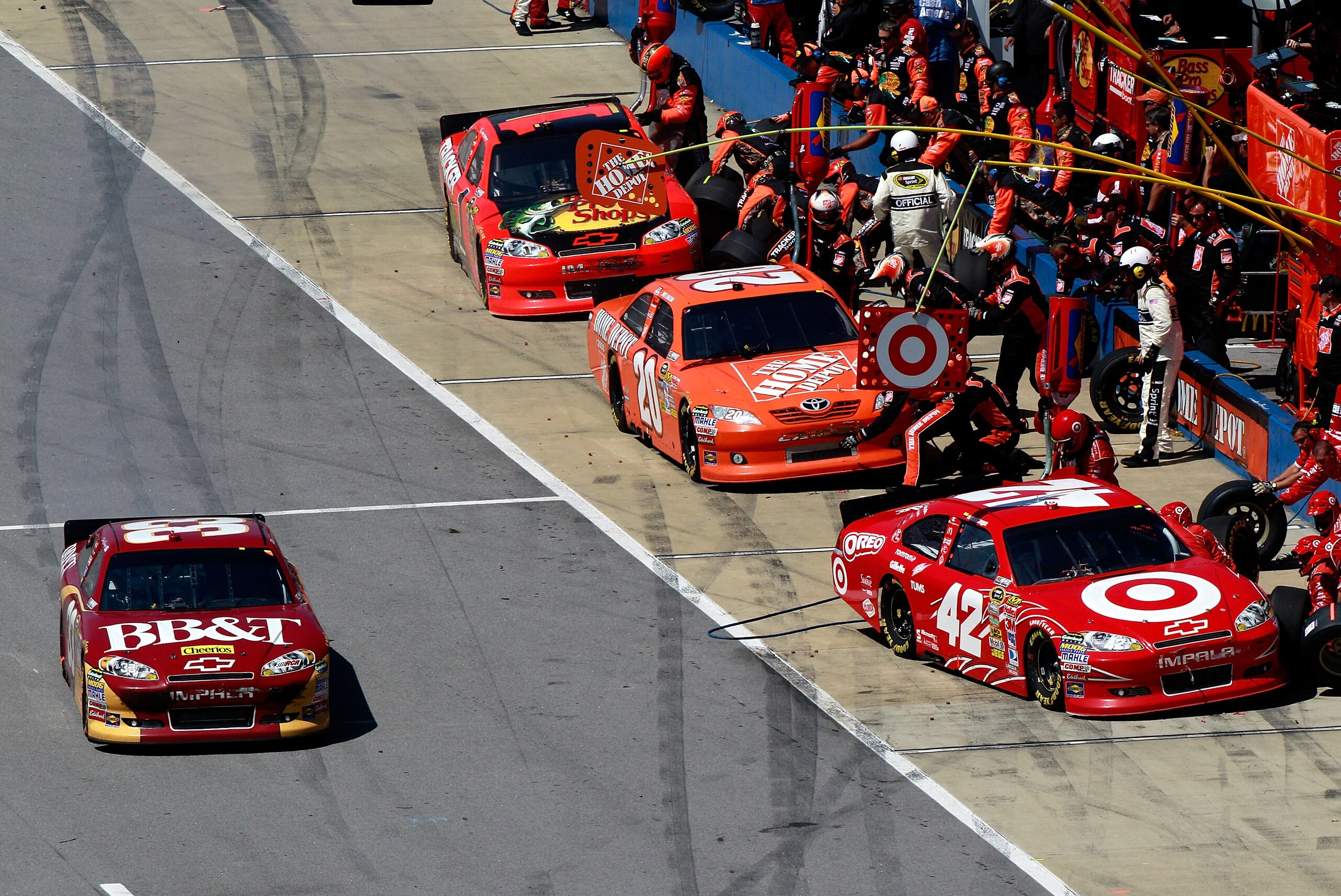 TALLADEGA, AL - APRIL 17:  Clint Bowyer, driver of the #33 BB&T Chevrolet, leaves pit road as Juan Pablo Montoya, driver of the #42 Target Chevrolet, Joey Logano, driver of the #20 Home Depot Toyota, and Jamie McMurray, driver of the #1 Bass Pro Shops/Tra