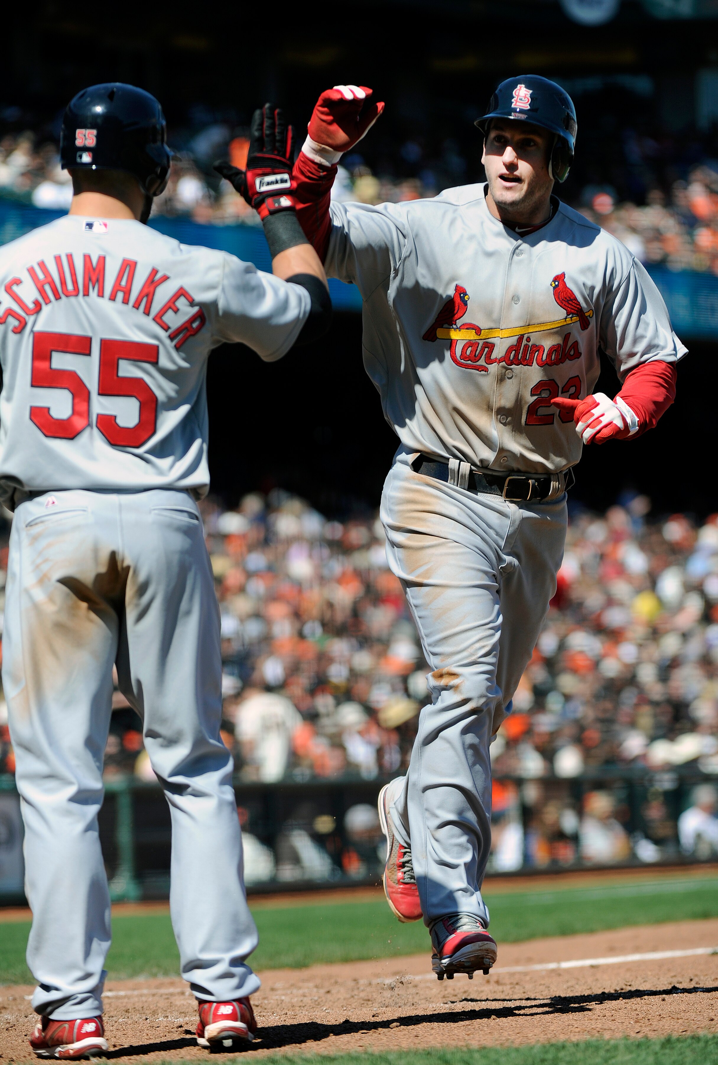 SAN FRANCISCO, CA - APRIL 10: David Freese #23 of the St. Louis Cardinals after hitting a home-run against the San Francisco Giants is met at home-plate with a high-five from teammate Skip Schumaker #55 during a MLB baseball game at AT&T Park April 10, 20
