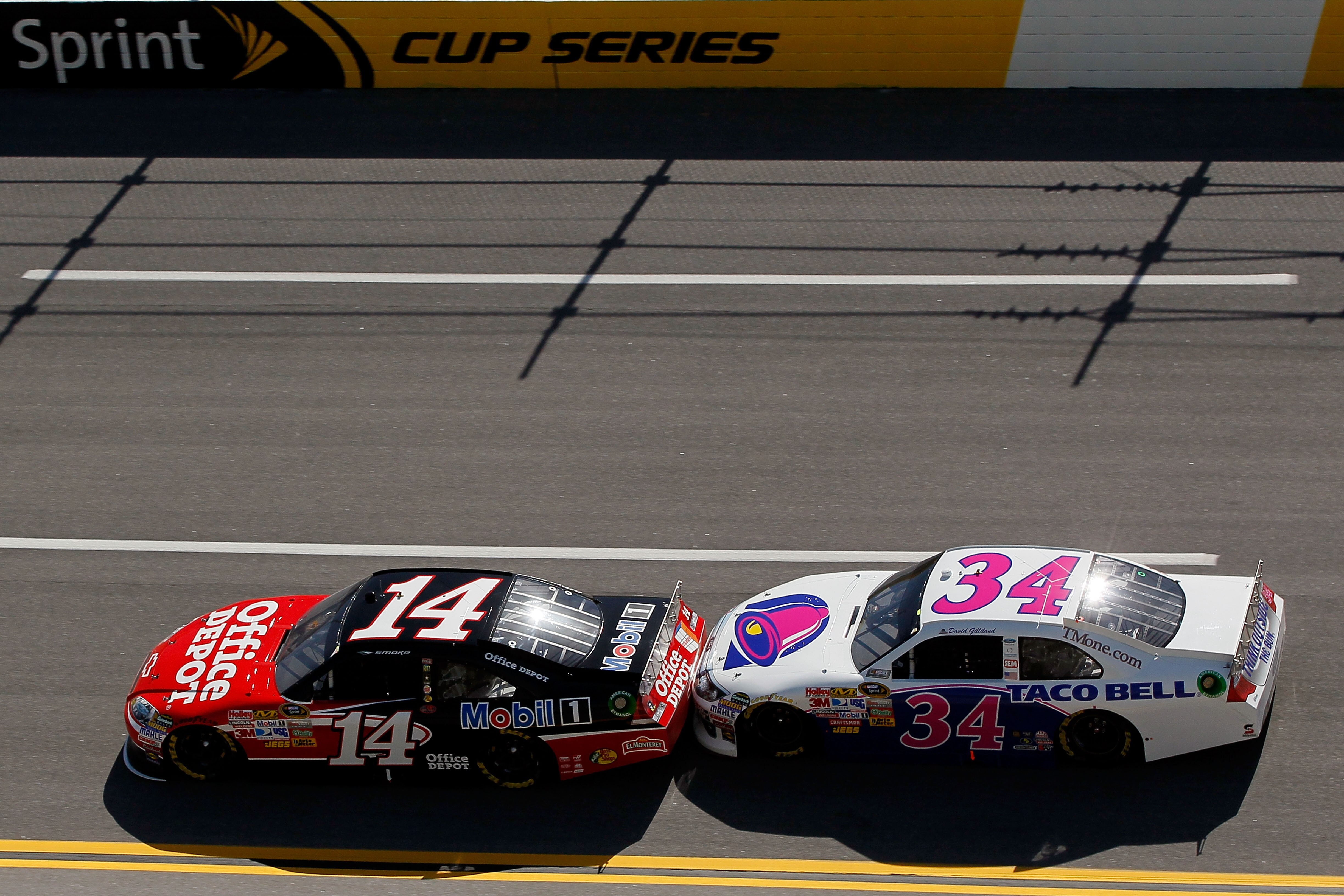 TALLADEGA, AL - APRIL 17:  Tony Stewart, driver of the #14 Office Depot/Mobil 1 Chevrolet, leads David Gilliland, driver of the #34 Taco Bell Ford, during the NASCAR Sprint Cup Series Aaron's 499 at Talladega Superspeedway on April 17, 2011 in Talladega,