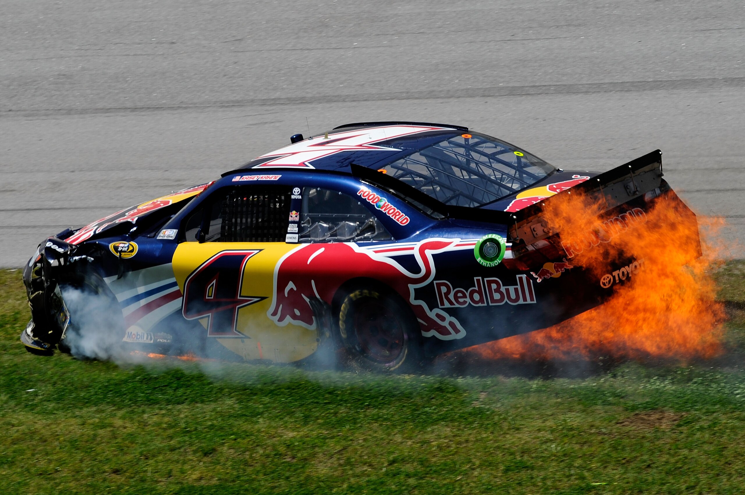 TALLADEGA, AL - APRIL 17:  Kasey Kahne, driver of the #4 Red Bull Toyota, slides through the grass while on fire after an incident in the NASCAR Sprint Cup Series Aaron's 499 at Talladega Superspeedway on April 17, 2011 in Talladega, Alabama.  (Photo by J