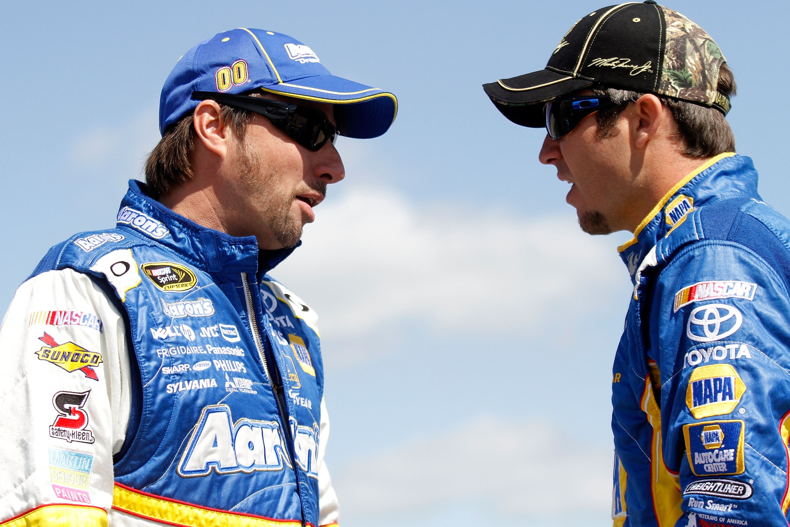 TALLADEGA, AL - APRIL 16:  David Reutimann (L), driver of the #00 Aaron's Coloring Contest Toyota, talks with Martin Truex Jr. (R), driver of the #56 NAPA Auto Parts Toyota, on the grid during qualifying for the NASCAR Sprint Cup Series Aaron's 499 at Tal