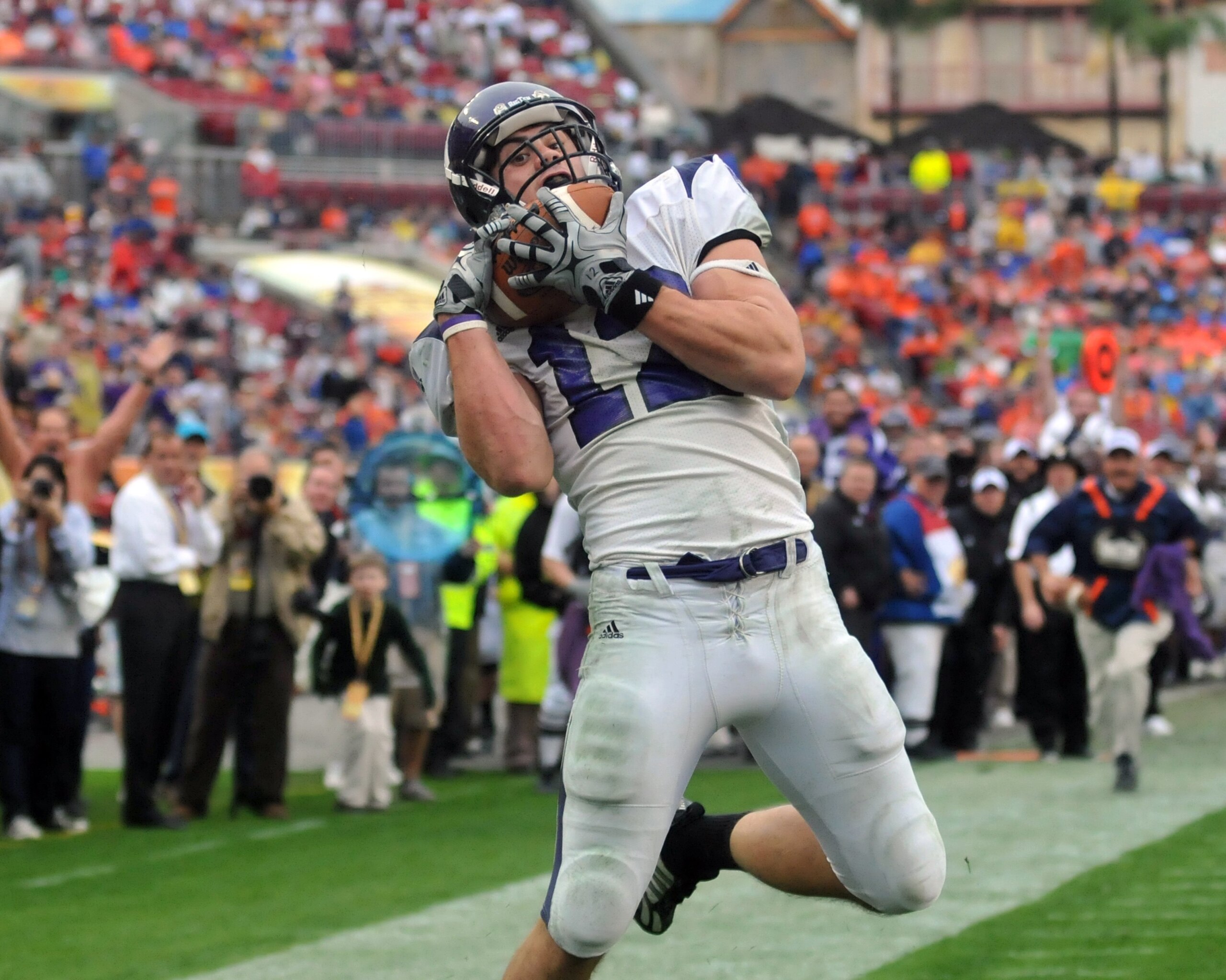 TAMPA, FL - JANUARY 1: Wide receiver Andrew Brewer #12 of the Northwestern Wildcats grabs a touchdown pass against the Auburn Tigers in the Outback Bowl January 1, 2010 at Raymond James Stadium in Tampa, Florida.  (Photo by Al Messerschmidt/Getty Images)