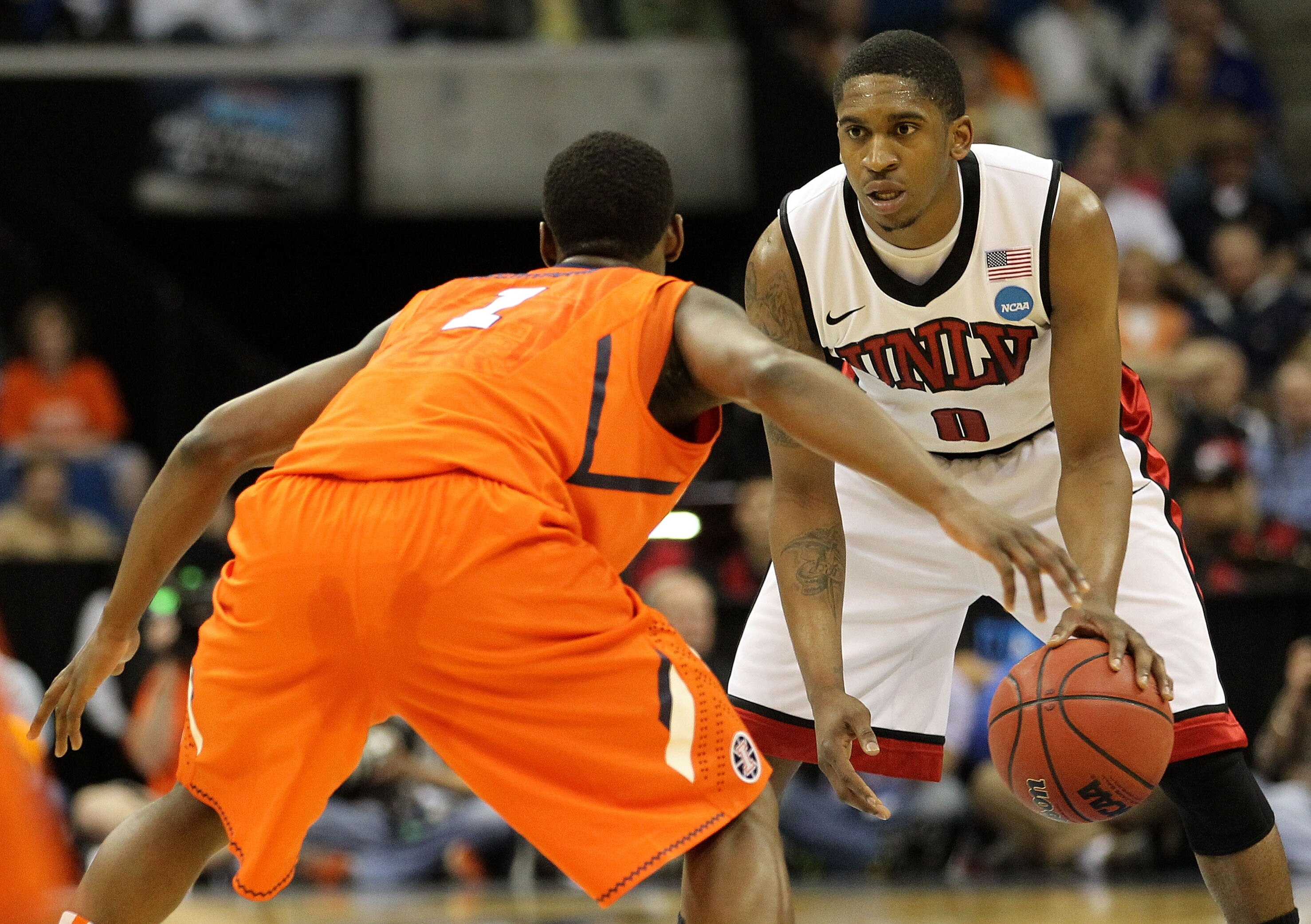 TULSA, OK - MARCH 18:  Oscar Bellfield #0 of the UNLV Rebels looks to move the ball as D.J. Richardson #1 of the Illinois Fighting Illini defends during the second round of the 2011 NCAA men's basketball tournament at BOK Center on March 18, 2011 in Tulsa
