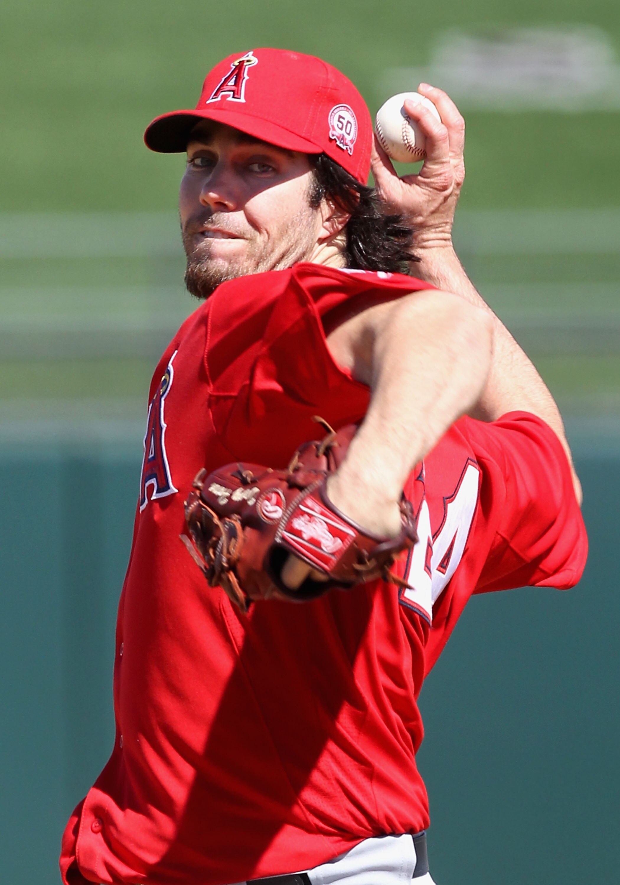 SURPRISE, AZ - MARCH 02:  Starting pitcher Dan Haren #24 of the Los Angeles Angels of Anaheim pitches against the Texas Rangers during the spring training game at Surprise Stadium on March 2, 2011 in Surprise, Arizona.  (Photo by Christian Petersen/Getty