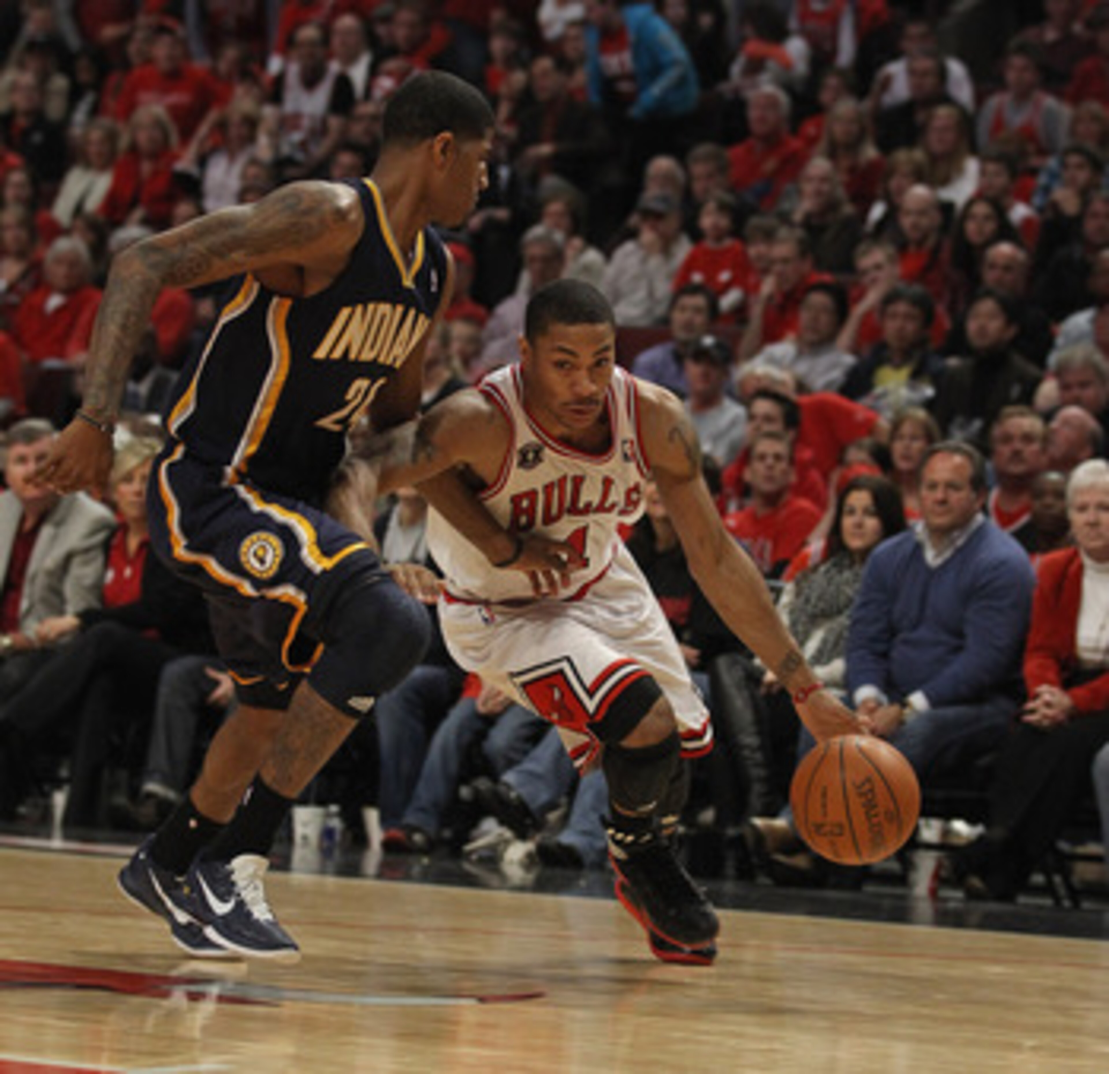 CHICAGO, IL - APRIL 16: Derrick Rose #1 of the Chicago Bulls drives around Paul George #24 of the Indiana Pacers in Game One of the Eastern Conference Quarterfinals in the 2011 NBA Playoffs at the United Center on April 16, 2011 in Chicago, Illinois. The
