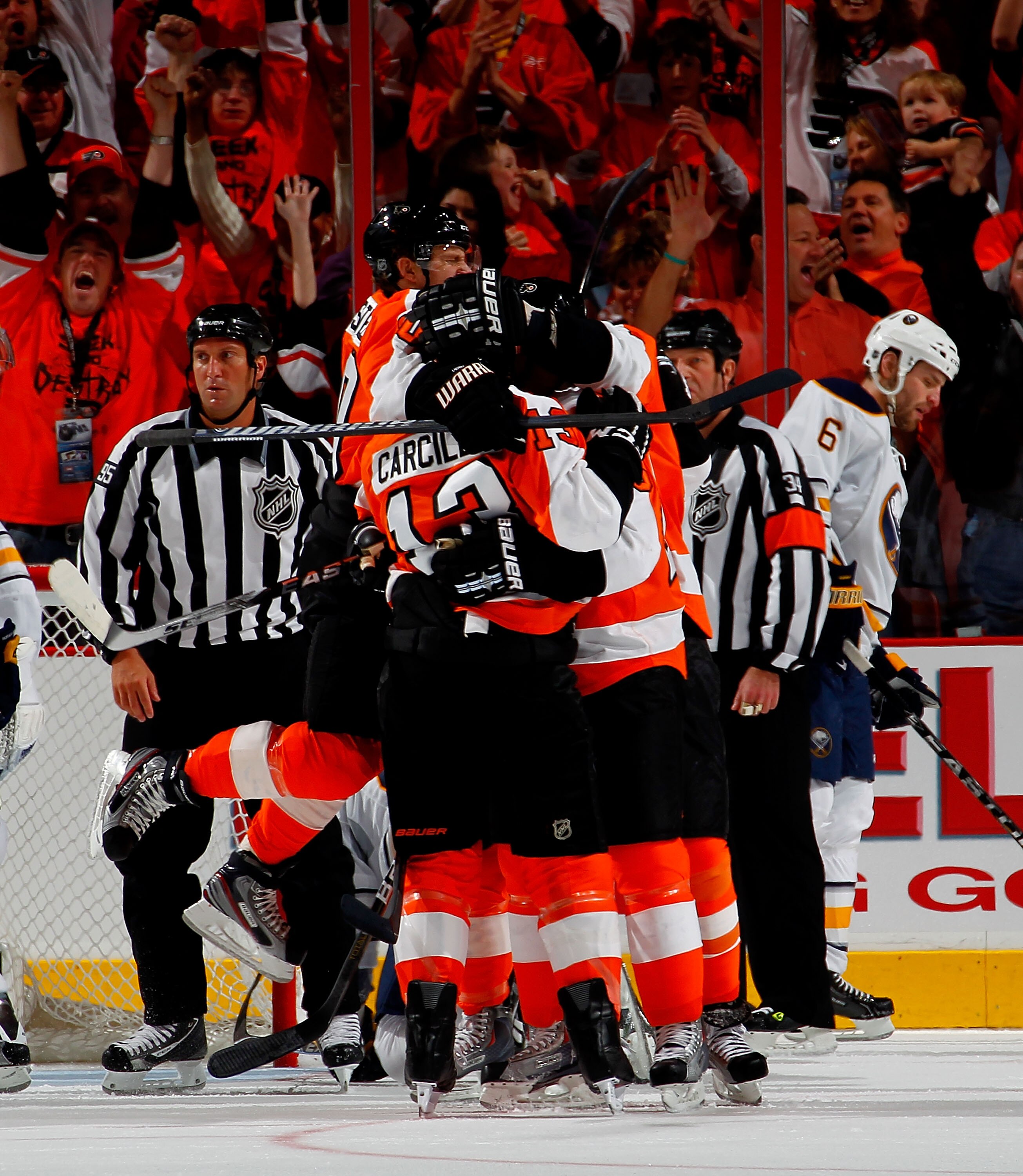 PHILADELPHIA, PA - APRIL 16:  Daniel Carcillo #13 of the Philadelphia Flyers is mobbed by teammates after scoring a goal while Mike Weber #6 of the Buffalo Sabres skates away during the first period of Game Two of the Eastern Conference Quarterfinals duri