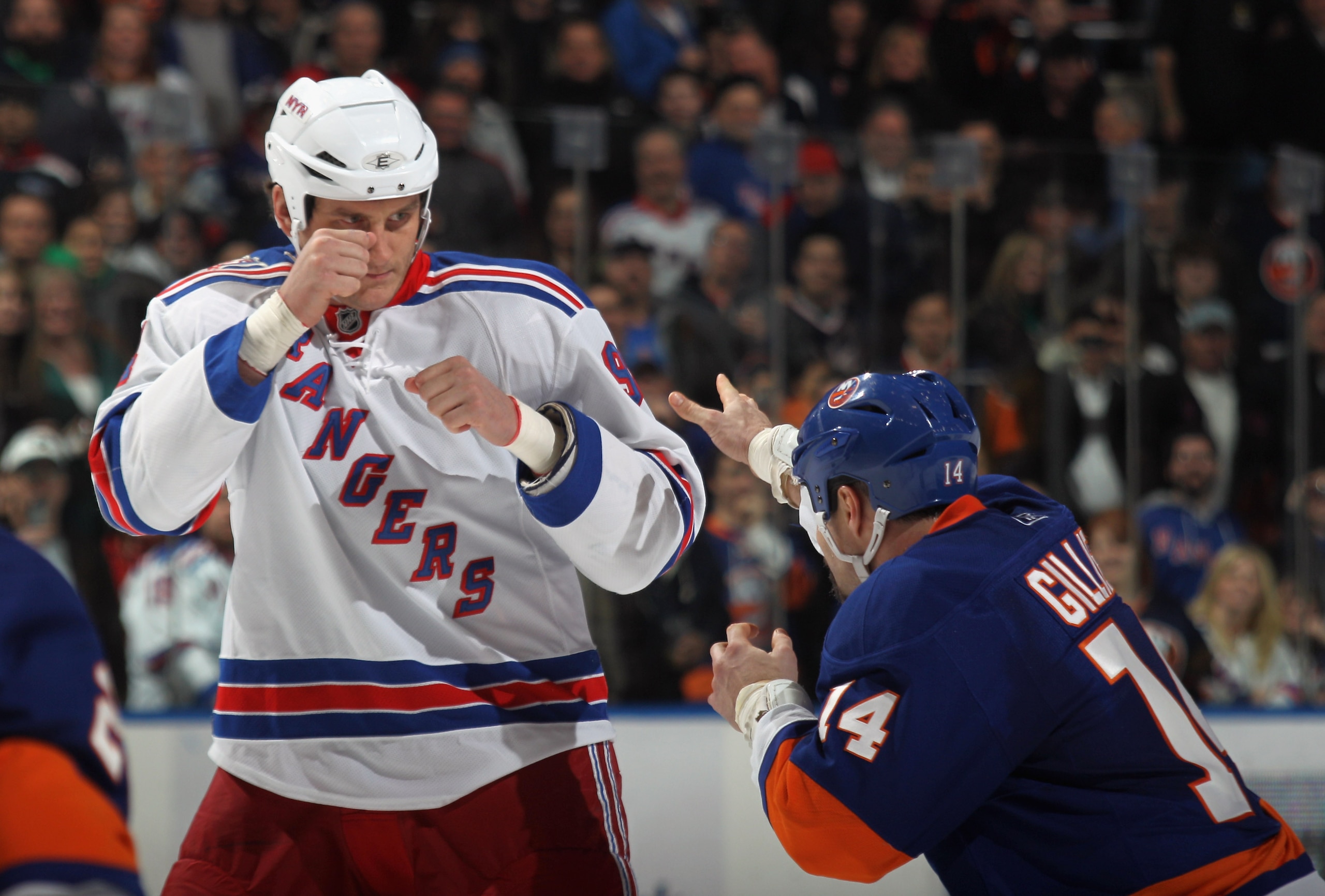 UNIONDALE, NY - DECEMBER 02: Derek Boogaard #94 of the New York Rangers fights with Trevor Gillies #14 of the New York Islanders at the Nassau Coliseum on December 2, 2010 in Uniondale, New York.  (Photo by Bruce Bennett/Getty Images)