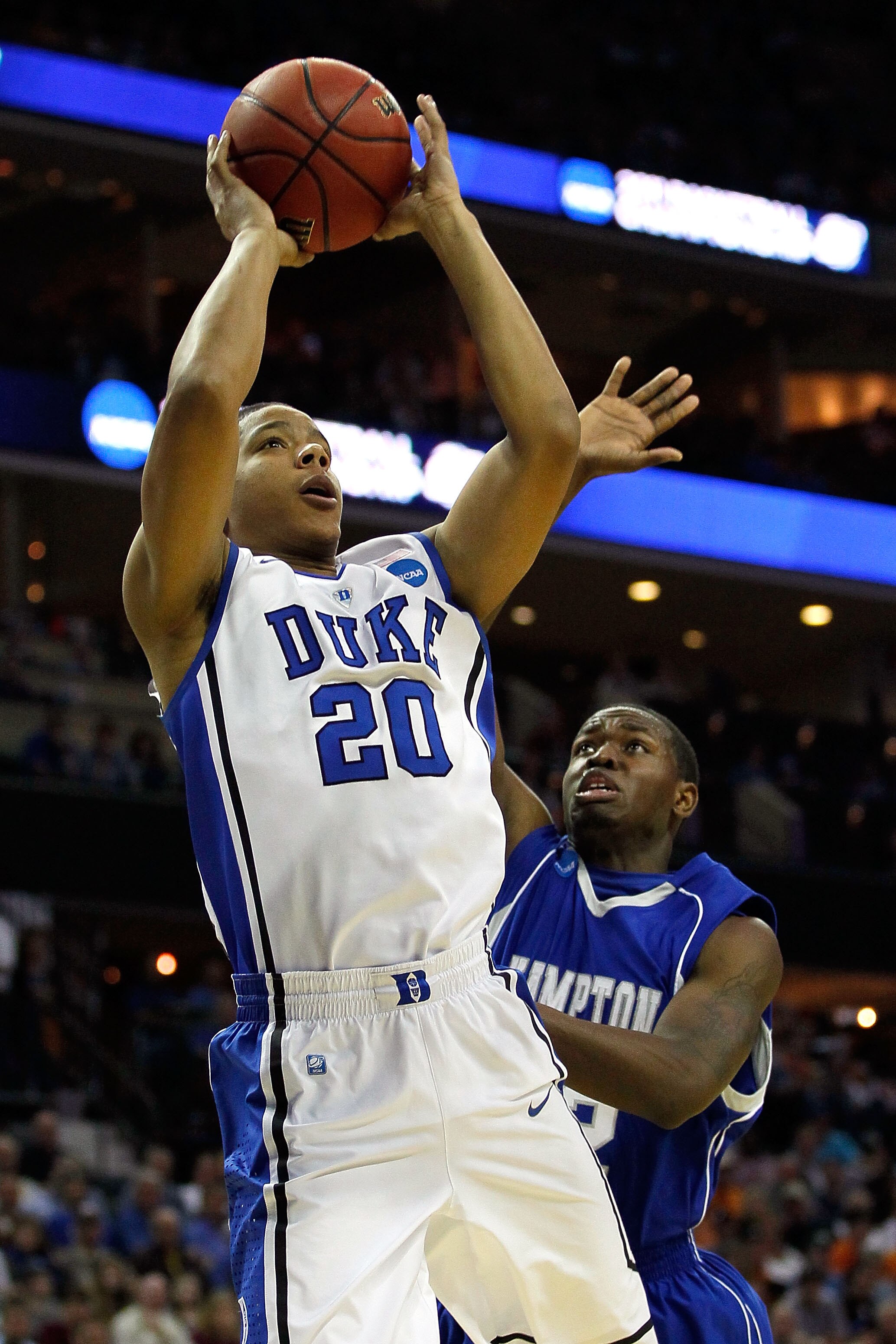 CHARLOTTE, NC - MARCH 18:  Andre Dawkins #20 of the Duke Blue Devils shoots the ball in front of Kwame Morgan II #32 of the Hampton Pirates in the first half during the second round of the 2011 NCAA men's basketball tournament at Time Warner Cable Arena o