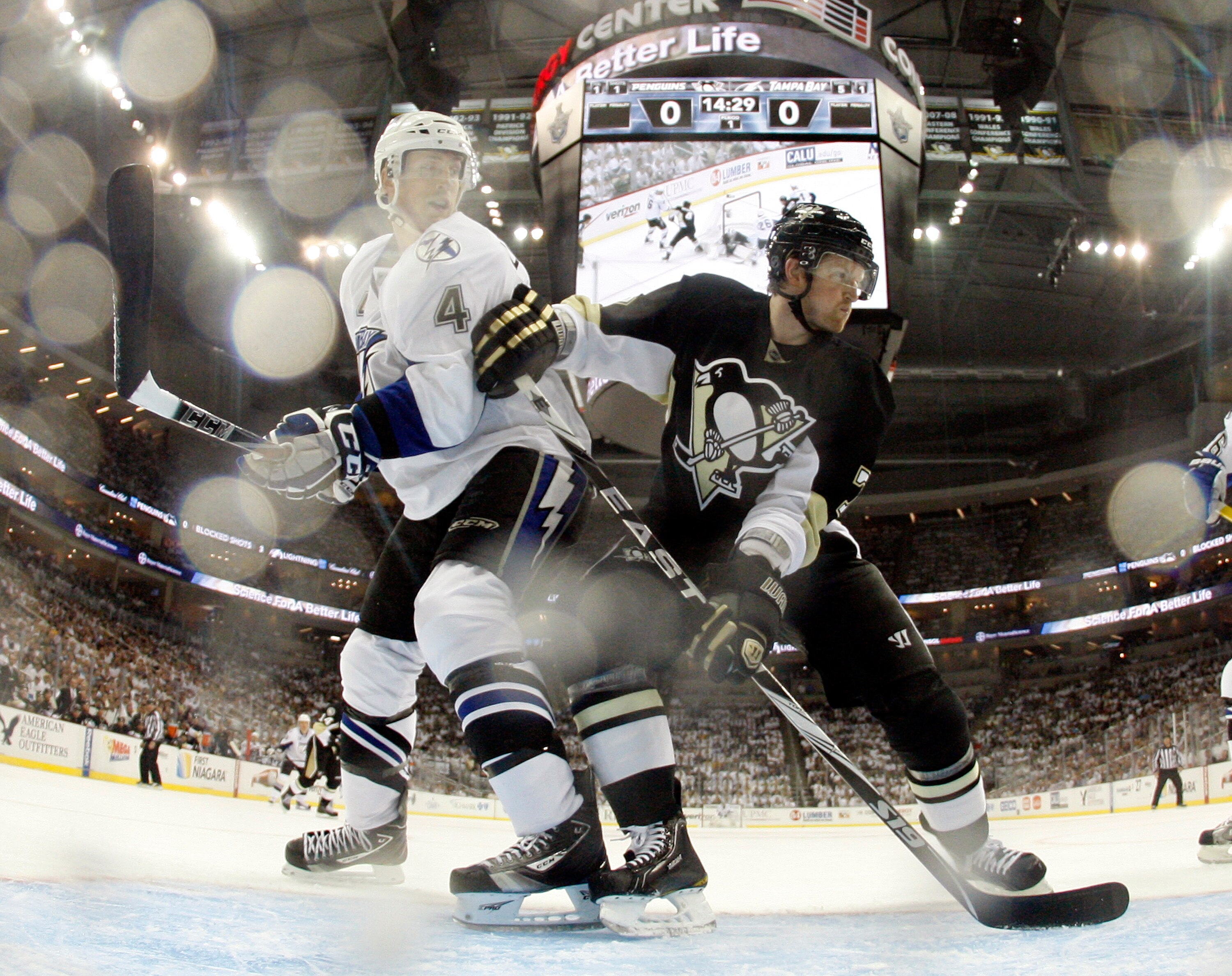 PITTSBURGH, PA - APRIL 13:  Paul Martin #7 of the Pittsburgh Penguins battles in front against Vincent Lecavalier #4 of the Tampa Bay Lightning in Game One of the Eastern Conference Quarterfinals during the 2011 NHL Stanley Cup Playoffs at Consol Energy C