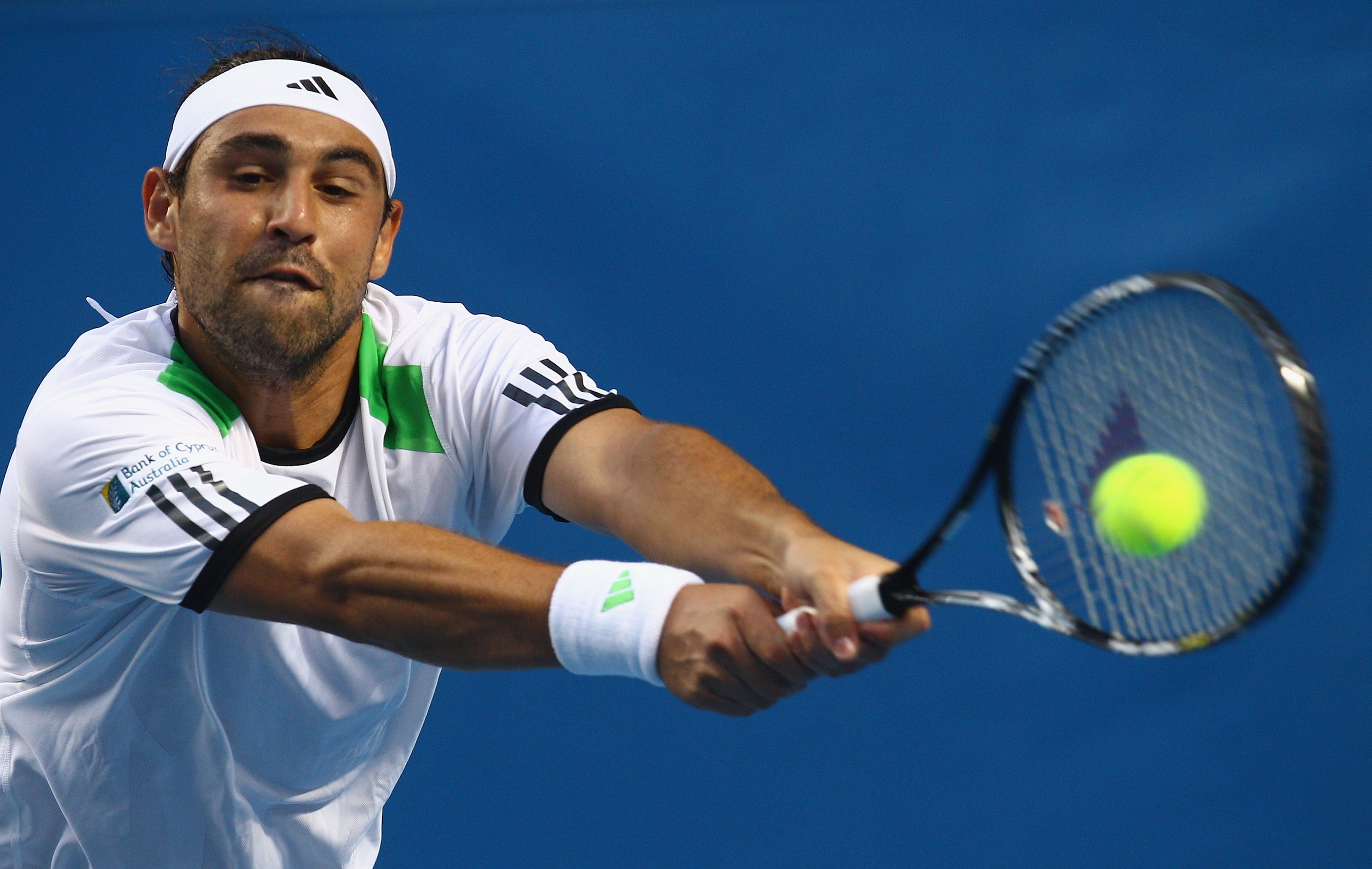 MELBOURNE, AUSTRALIA - JANUARY 22:  Marcos Baghdatis of Cyprus plays a backhand n his third round match against Jurgen Melzer of Austria during day six of the 2011 Australian Open at Melbourne Park on January 22, 2011 in Melbourne, Australia.  (Photo by Q