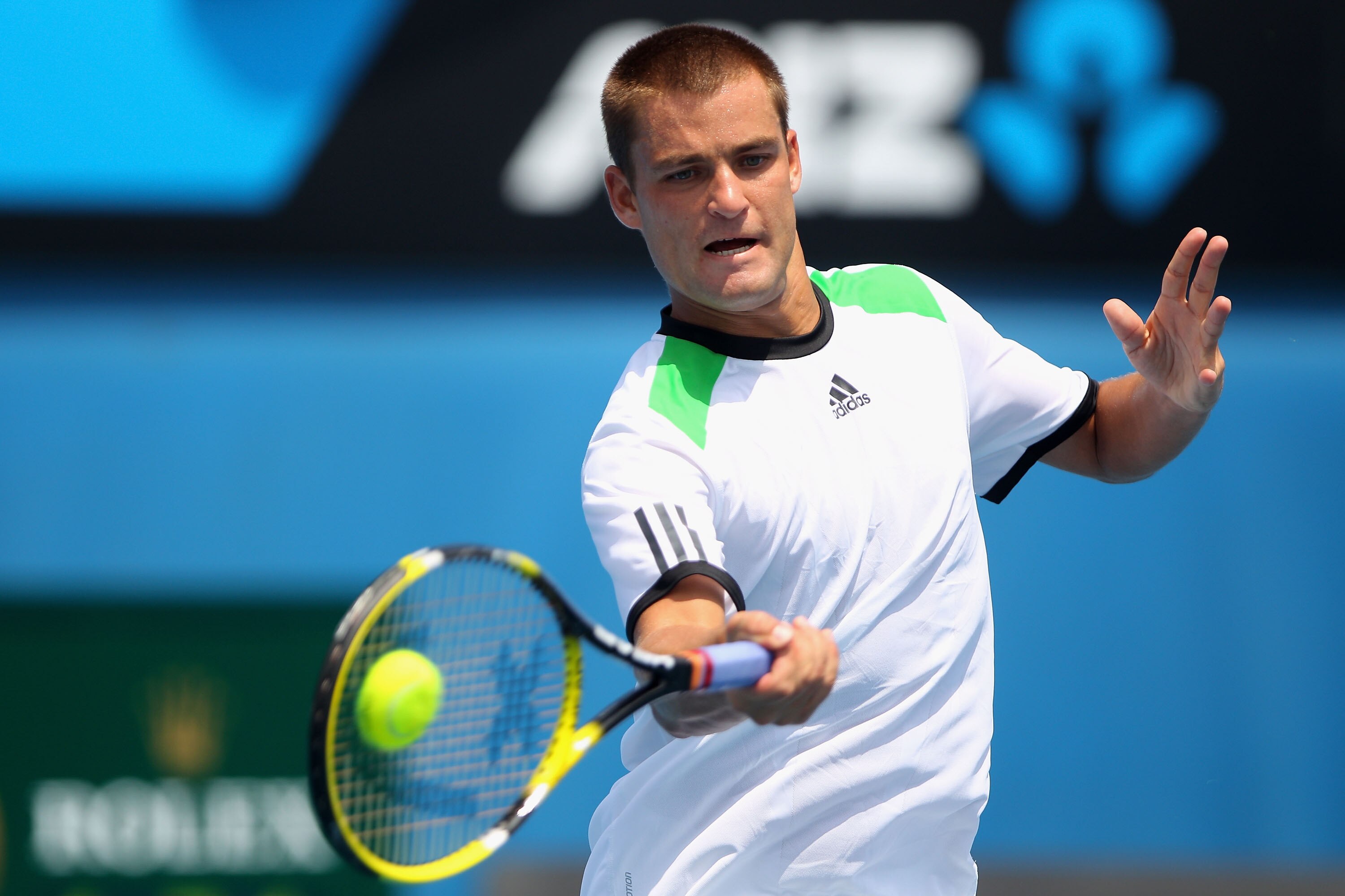 MELBOURNE, AUSTRALIA - JANUARY 22:  Mikhail Youzhny of Russia plays a forehand during his third round match against Milos Raonic of Canada during day six of the 2011 Australian Open at Melbourne Park on January 22, 2011 in Melbourne, Australia.  (Photo by