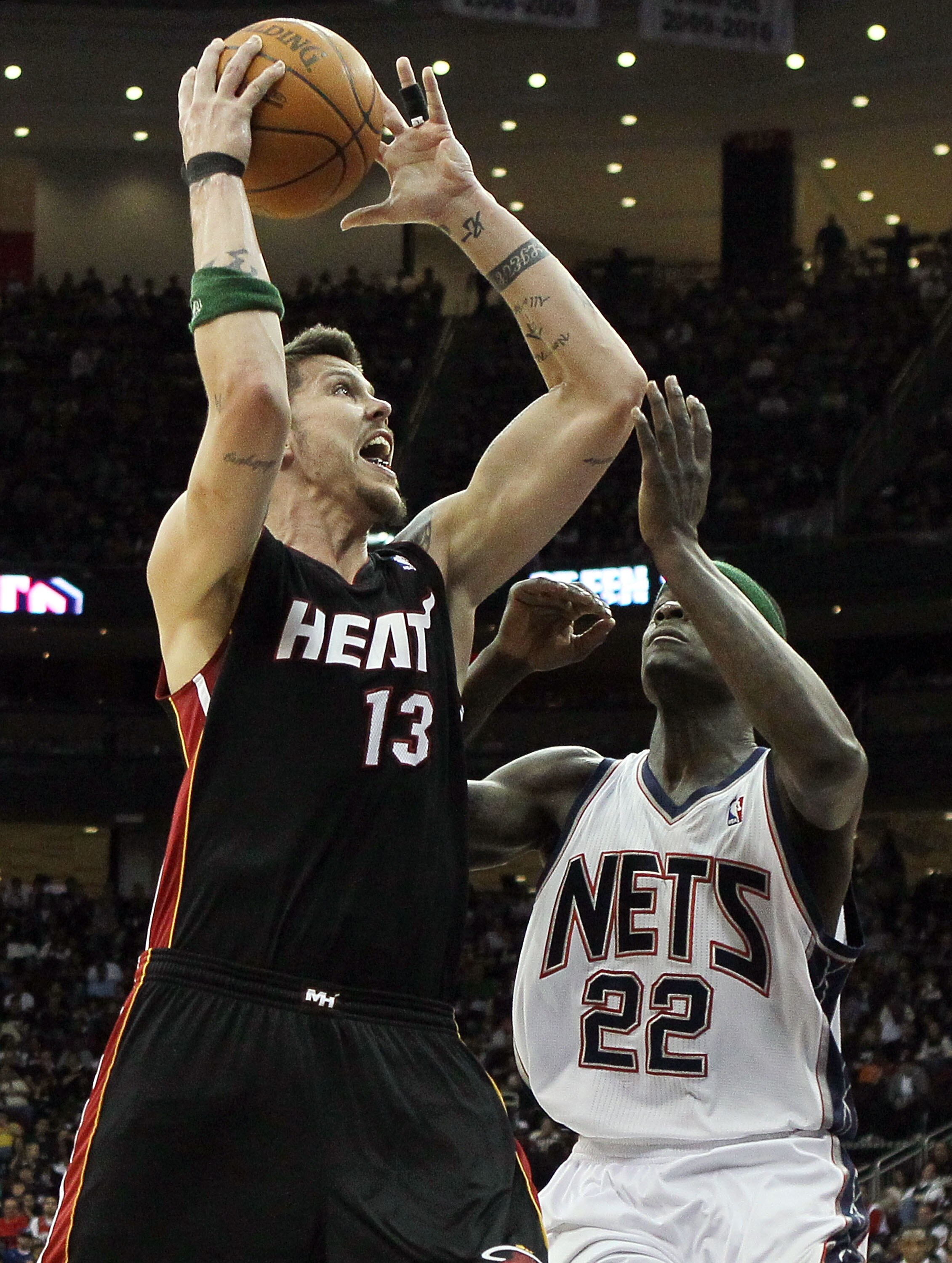 NEWARK, NJ - APRIL 03:  Mike Miller #13 of the Miami Heat puts up a shot against Anthony Morrow #22 of the New Jersey Nets at the Prudential Center on April 3, 2011 in Newark, New Jersey.NOTE TO USER: User expressly acknowledges and agrees that, by downlo