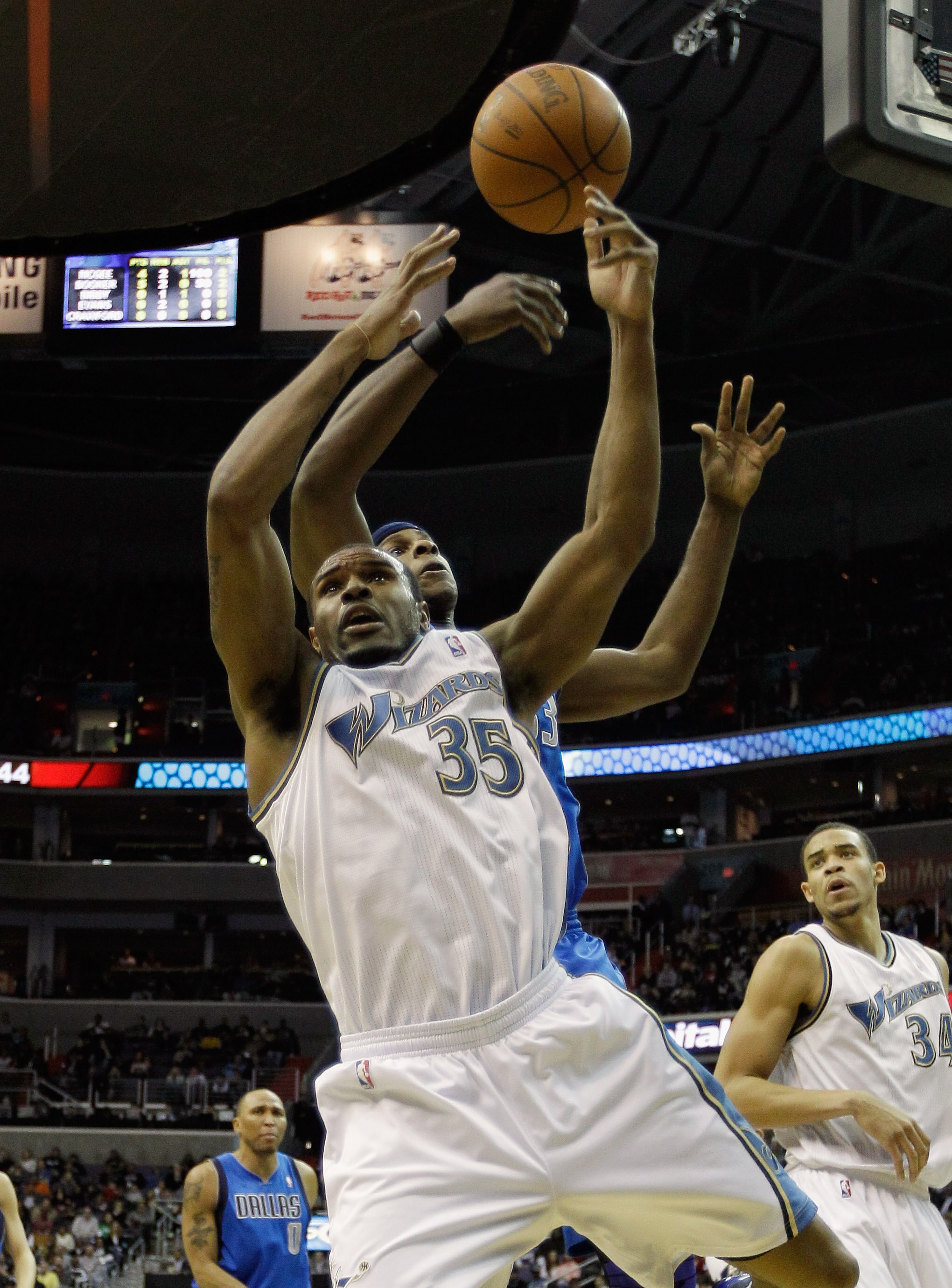 WASHINGTON, DC - FEBRUARY 26: Trevor Booker #35 of the Washington Wizards and Brendan Haywood #33 of the Dallas Mavericks go up for a rebound at the Verizon Center on February 26, 2011 in Washington, DC. NOTE TO USER: User expressly acknowledges and agree