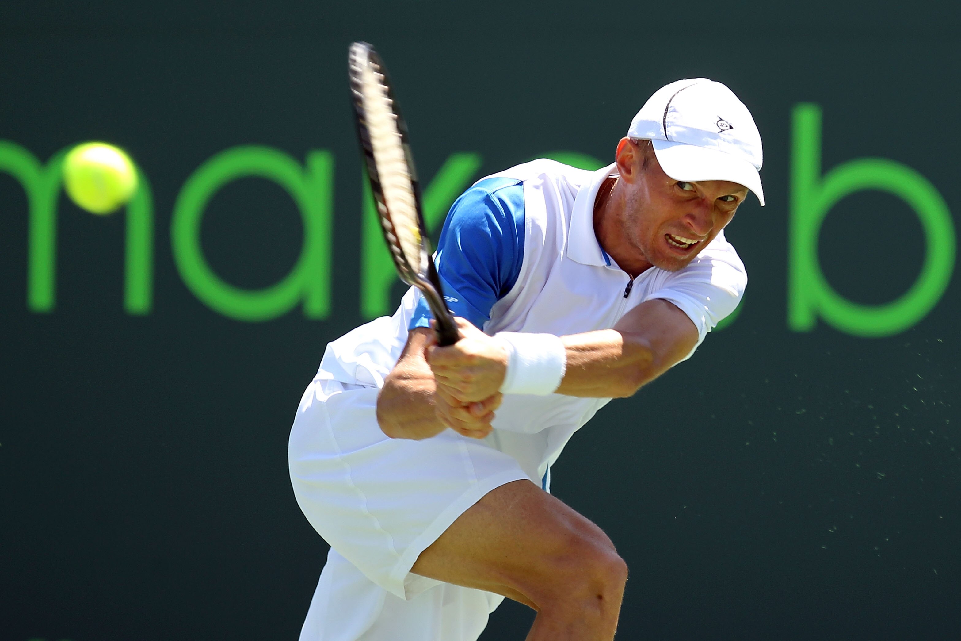 KEY BISCAYNE, FL - MARCH 23:  Nikolay Davydenko of Russia hits a return against Kevin Anderson of South Africa during the Sony Ericsson Open at Crandon Park Tennis Center on March 23, 2011 in Key Biscayne, Florida.  (Photo by Al Bello/Getty Images)