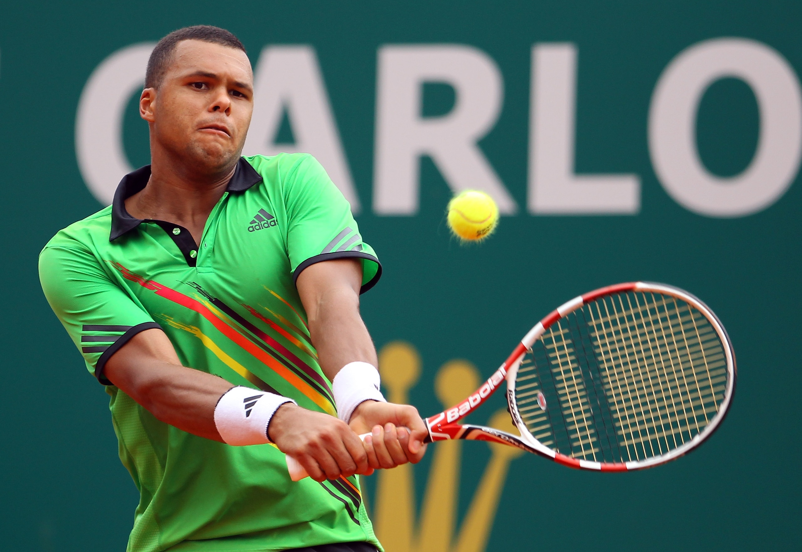 MONACO - APRIL 12:  Jo-Wilfried Tsonga of France plays a backhand in his match against Ivan Ljubicic of Croatia during Day Three of the ATP Masters Series Tennis at the Monte Carlo Country Club on April 12, 2011 in Monte Carlo, Monaco.  (Photo by Julian F