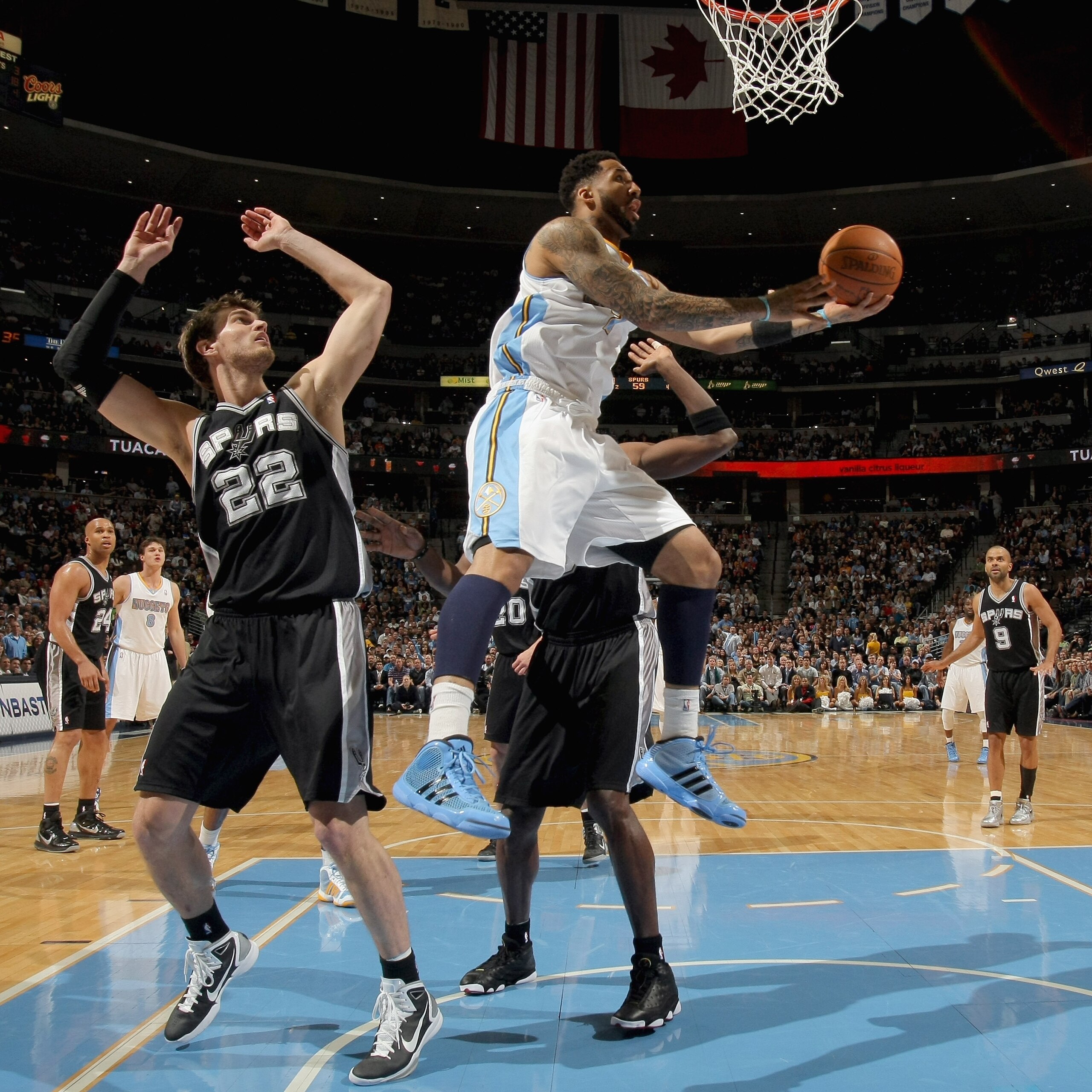 DENVER, CO - MARCH 23:  Wilson Chandler #21 of the Denver Nuggets after beating the defense of Tiago Splitter #22 of the San Antonio Spurs at the Pepsi Center on March 23, 2011 in Denver, Colorado. NOTE TO USER: User expressly acknowledges and agrees that