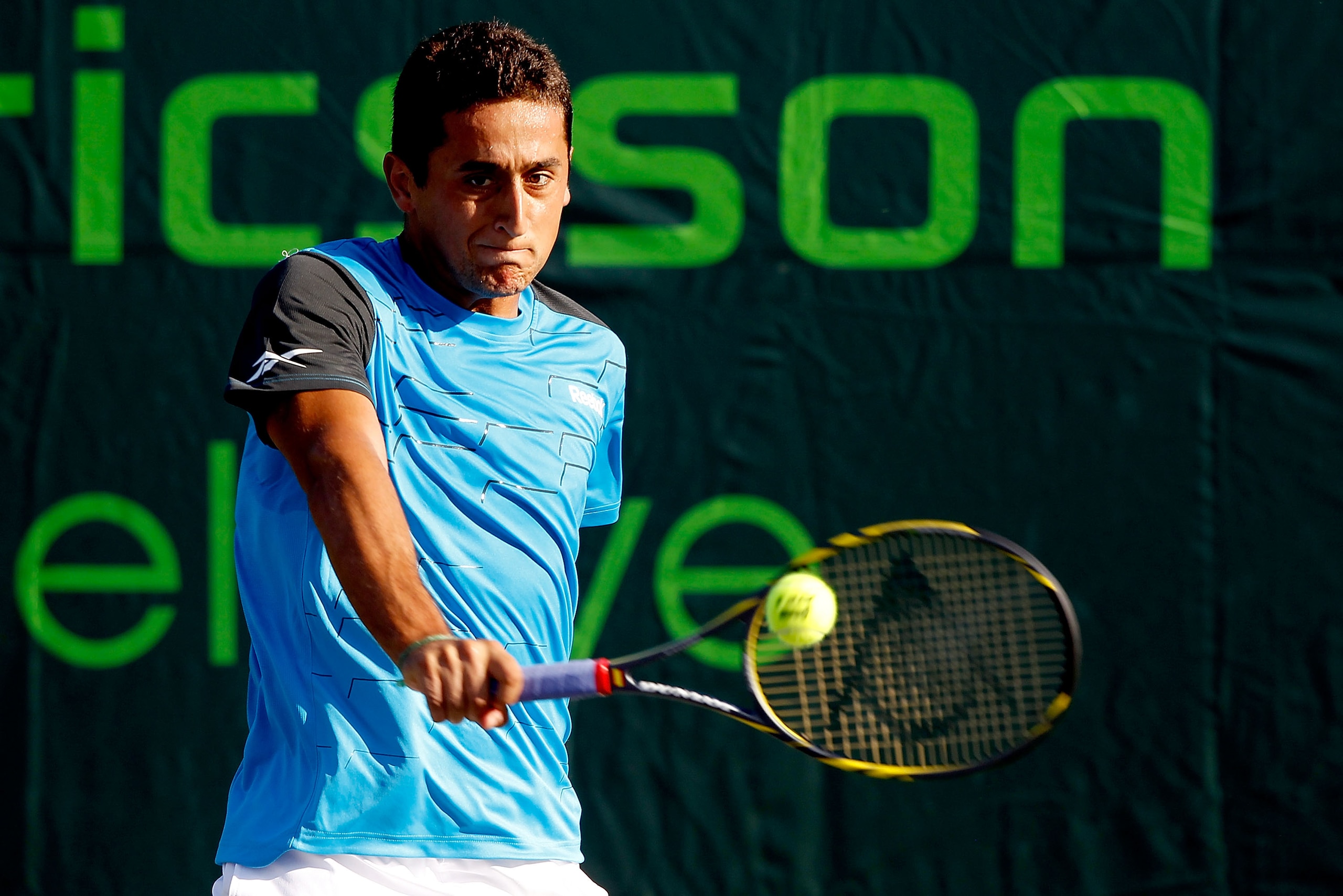 KEY BISCAYNE, FL - MARCH 26:  Nicolas Almagro of Spain hits a return against Frederico Gil of Portugal during the Sony Ericsson Open at Crandon Park Tennis Center on March 26, 2011 in Key Biscayne, Florida.  (Photo by Matthew Stockman/Getty Images)