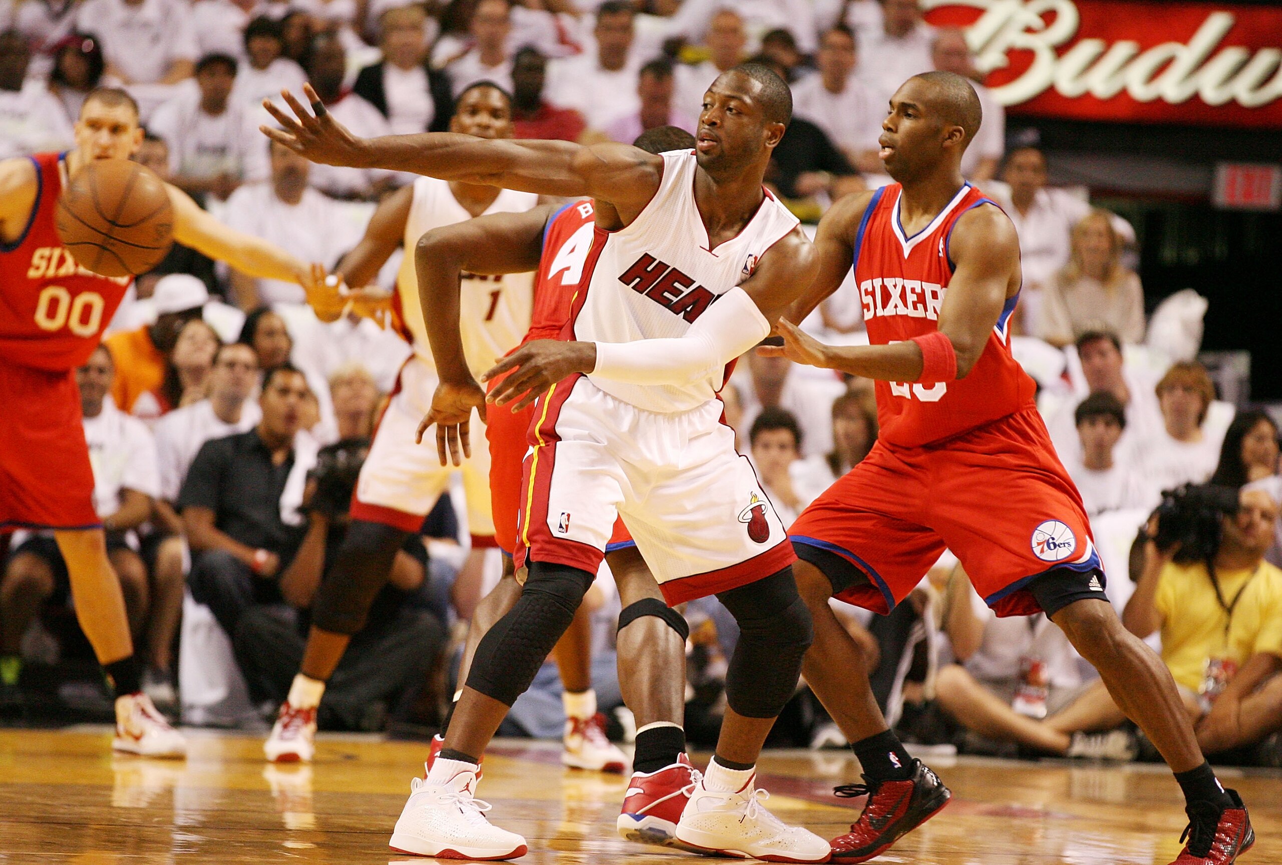 MIAMI, FL - APRIL 16:  Guard Dwyane Wade #3 of the Miami Heat passes against guard Jodie Meeks #20 of  the Philadelphia 76ers at the American Airlines Arena in game one of the Eastern Conference Quarterfinals in the 2011 NBA Playoffs on April 16, 2011 in