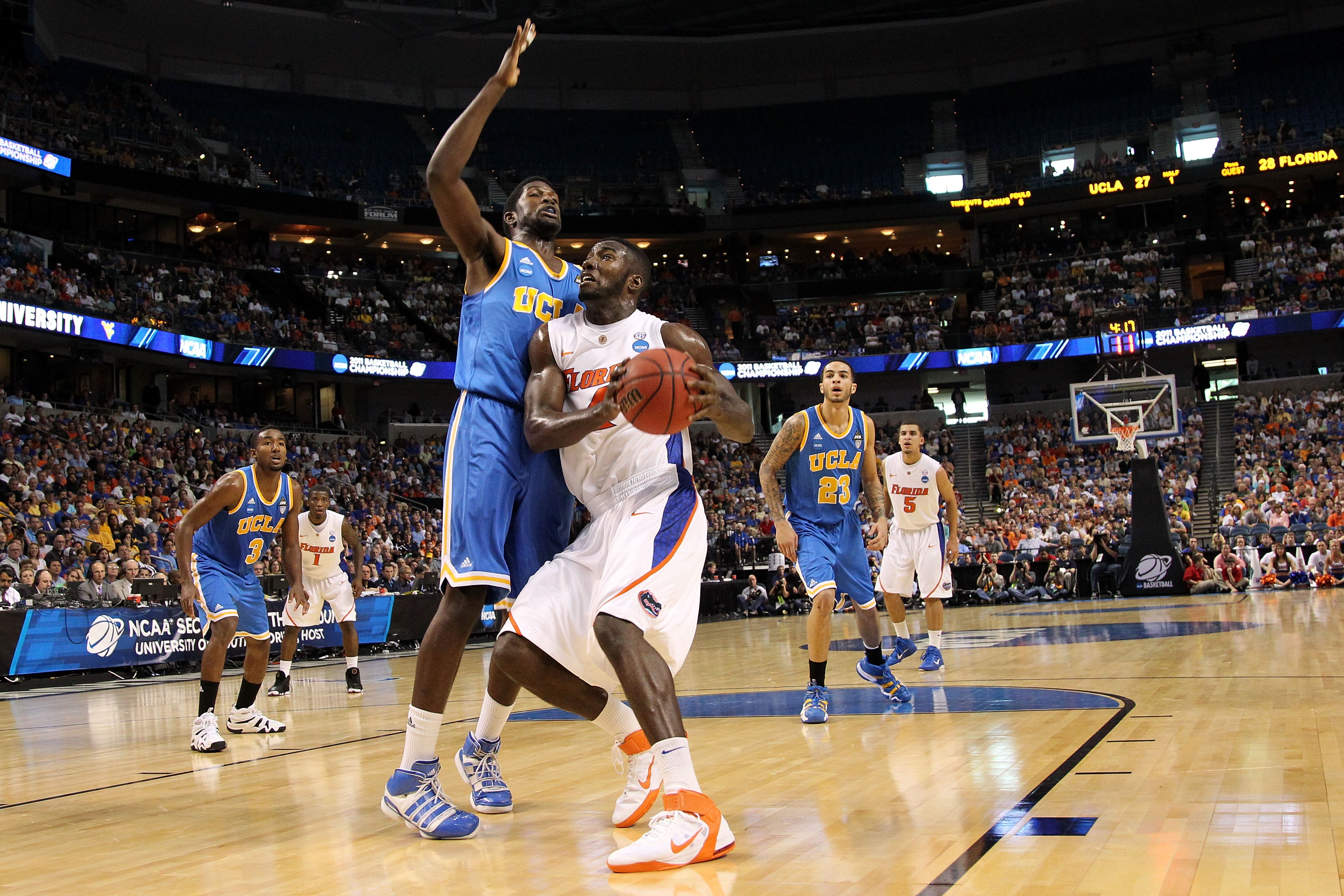 TAMPA, FL - MARCH 19:  Patric Young #4 of the Florida Gators drives against Anthony Stover #0 of the UCLA Bruins during the third round of the 2011 NCAA men's basketball tournament at St. Pete Times Forum on March 19, 2011 in Tampa, Florida. Florida won 7