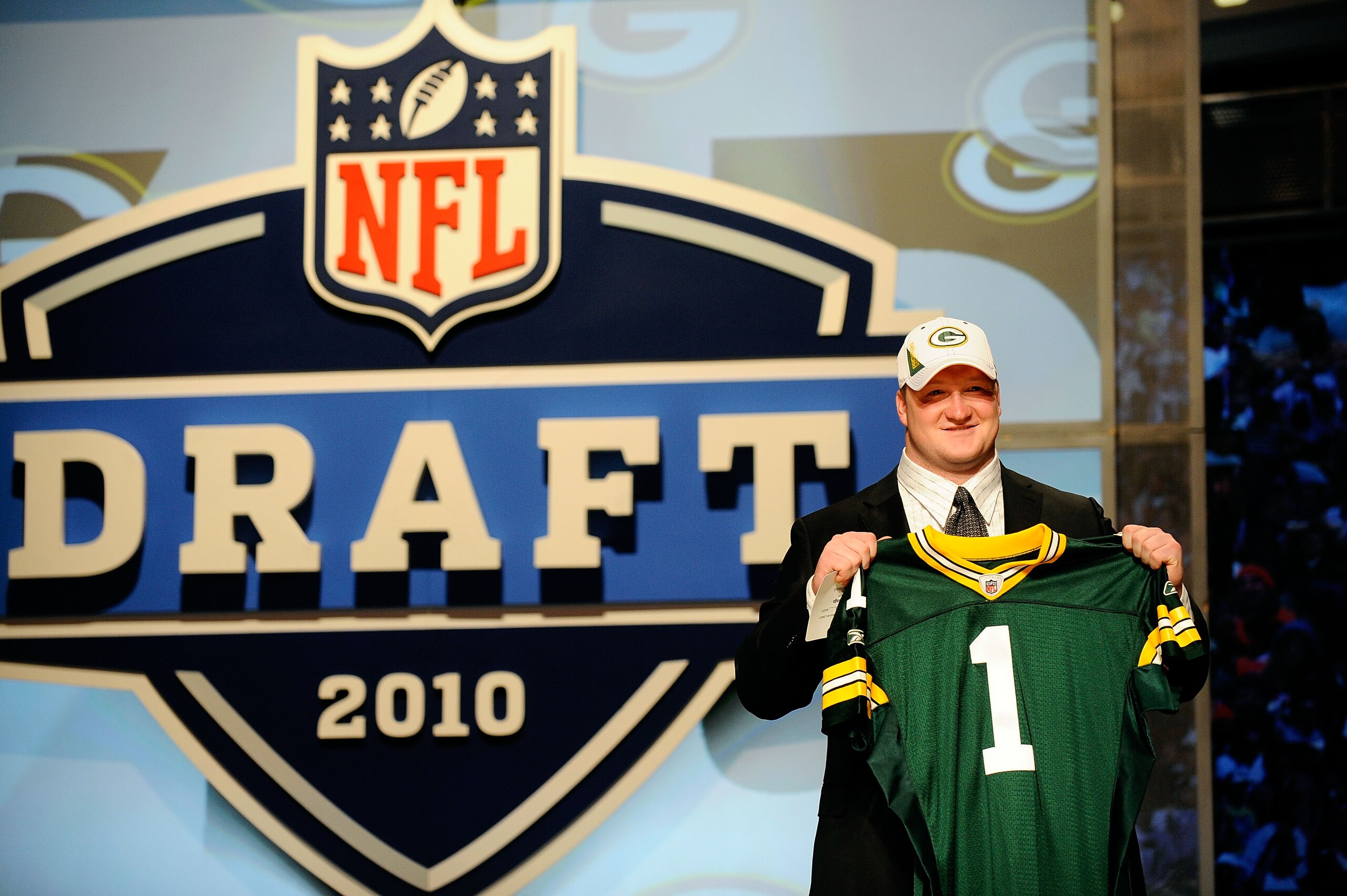 NEW YORK - APRIL 22:  Bryan Bulaga from the Iowa Hawkeyes holds up a Green Bay Packers jersey after the Packers drafted him number 23 overall during the first round of the 2010 NFL Draft at Radio City Music Hall on April 22, 2010 in New York City.  (Photo