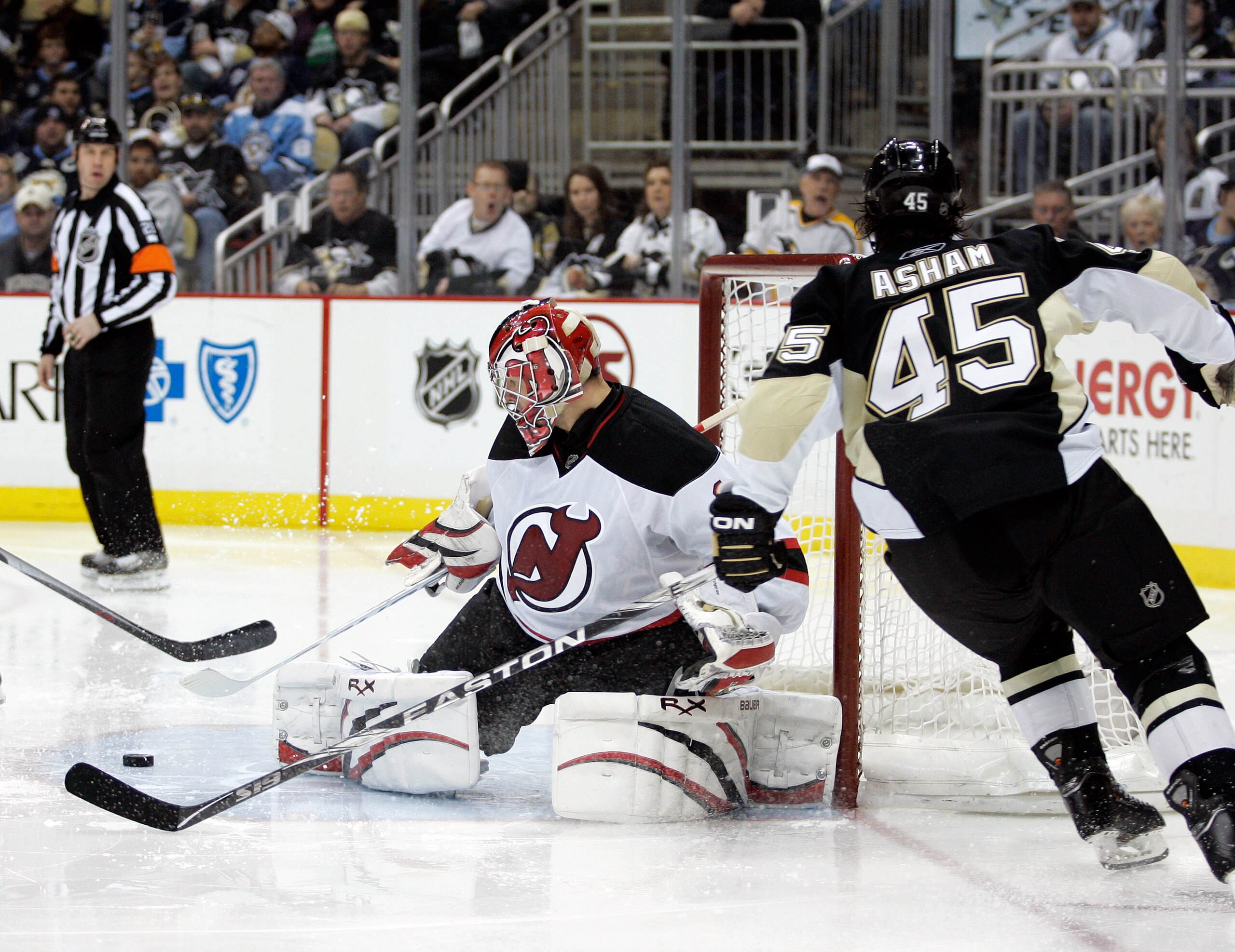 PITTSBURGH, PA - APRIL 05:  Johan Hedberg #1 of the New Jersey Devils makes a save on Arron Asham #45 of the Pittsburgh Penguins at Consol Energy Center on April 5, 2011 in Pittsburgh, Pennsylvania.  The Penguins defeated the Devils 4-2.  (Photo by Justin