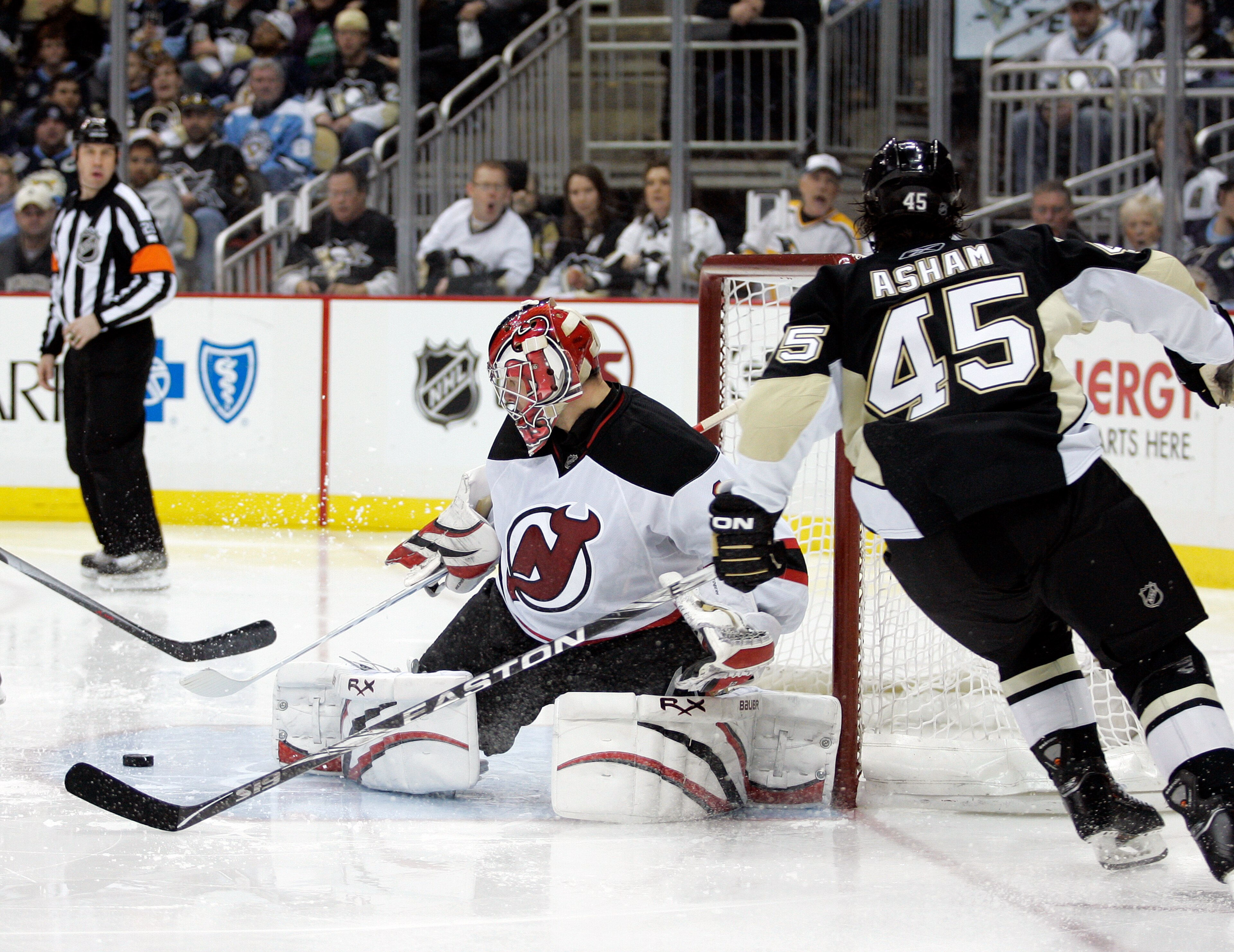 PITTSBURGH, PA - APRIL 05:  Johan Hedberg #1 of the New Jersey Devils makes a save on Arron Asham #45 of the Pittsburgh Penguins at Consol Energy Center on April 5, 2011 in Pittsburgh, Pennsylvania.  The Penguins defeated the Devils 4-2.  (Photo by Justin