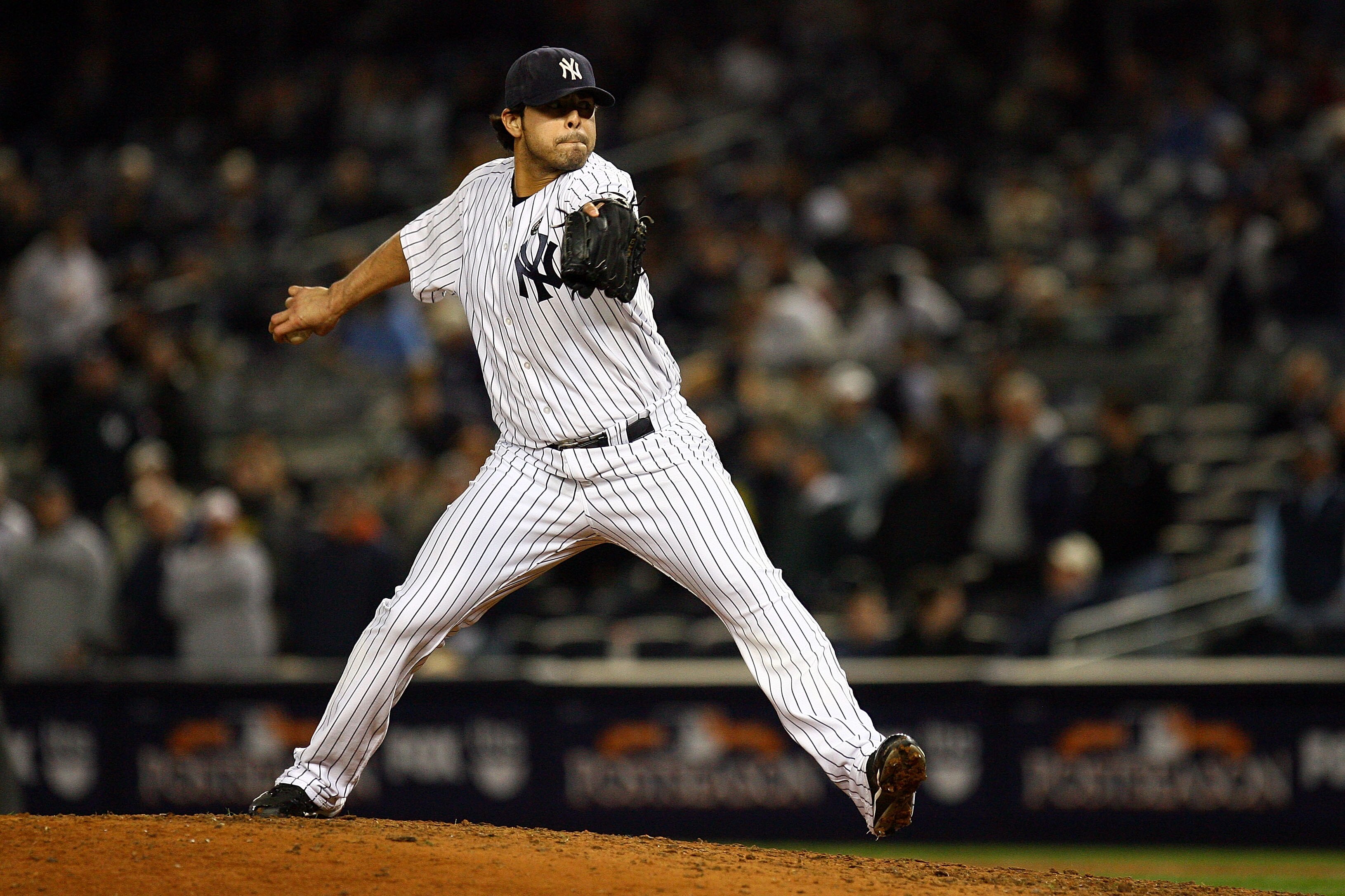 NEW YORK - OCTOBER 19:  Sergio Mitre #45 of the New York Yankees pitches against the Texas Rangers in Game Four of the ALCS during the 2010 MLB Playoffs at Yankee Stadium on October 19, 2010 in the Bronx borough of New York City. The Rangers won 10-3.  (P