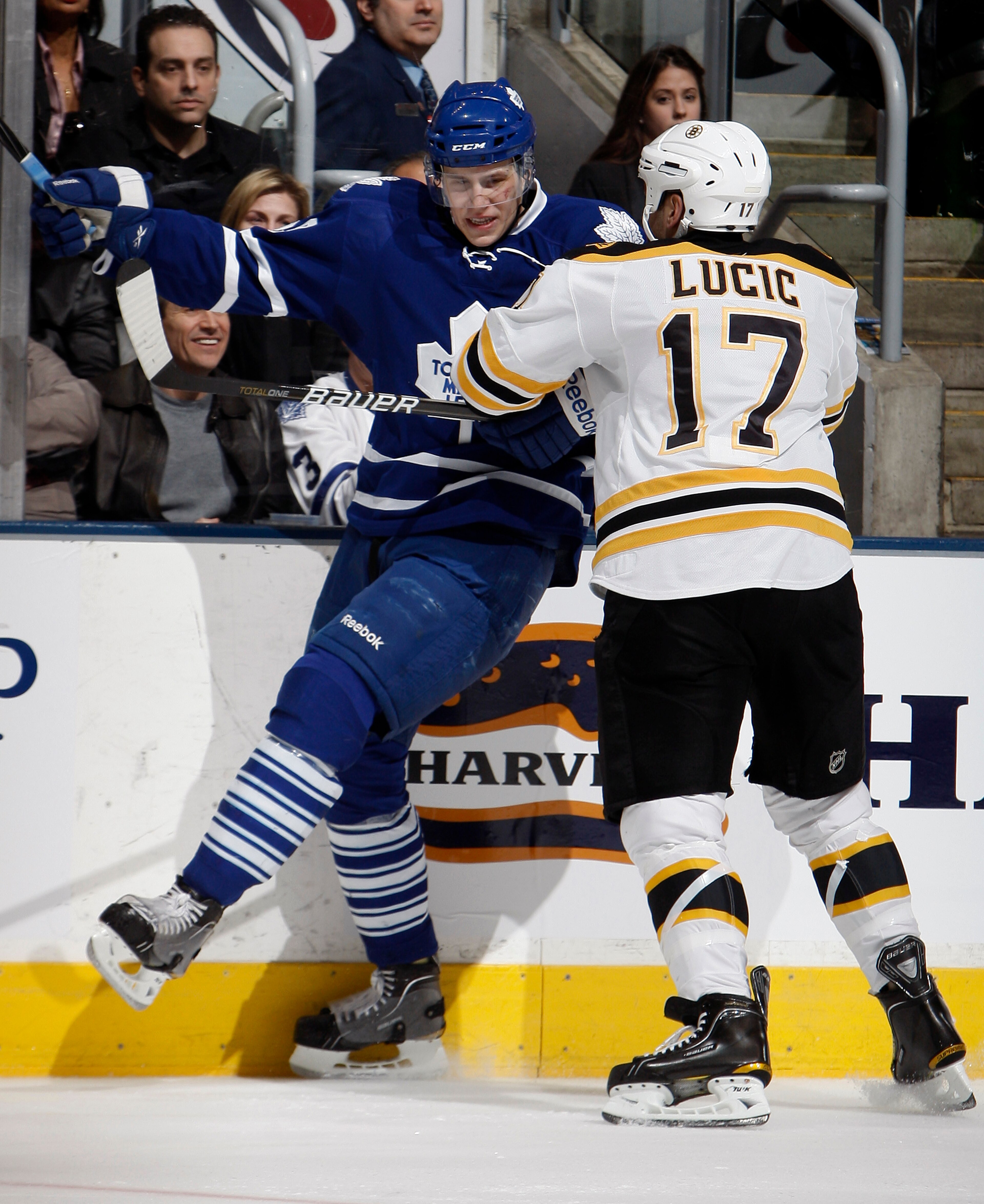 TORONTO, CANADA - MARCH 19 Milan Lucic #17 of the Boston Bruins pushes Keith Aulie #59 of the Toronto Maple Leafs during game action at the Air Canada Centre March 19, 2011 in Toronto, Ontario, Canada. (Photo by Abelimages/Getty Images)