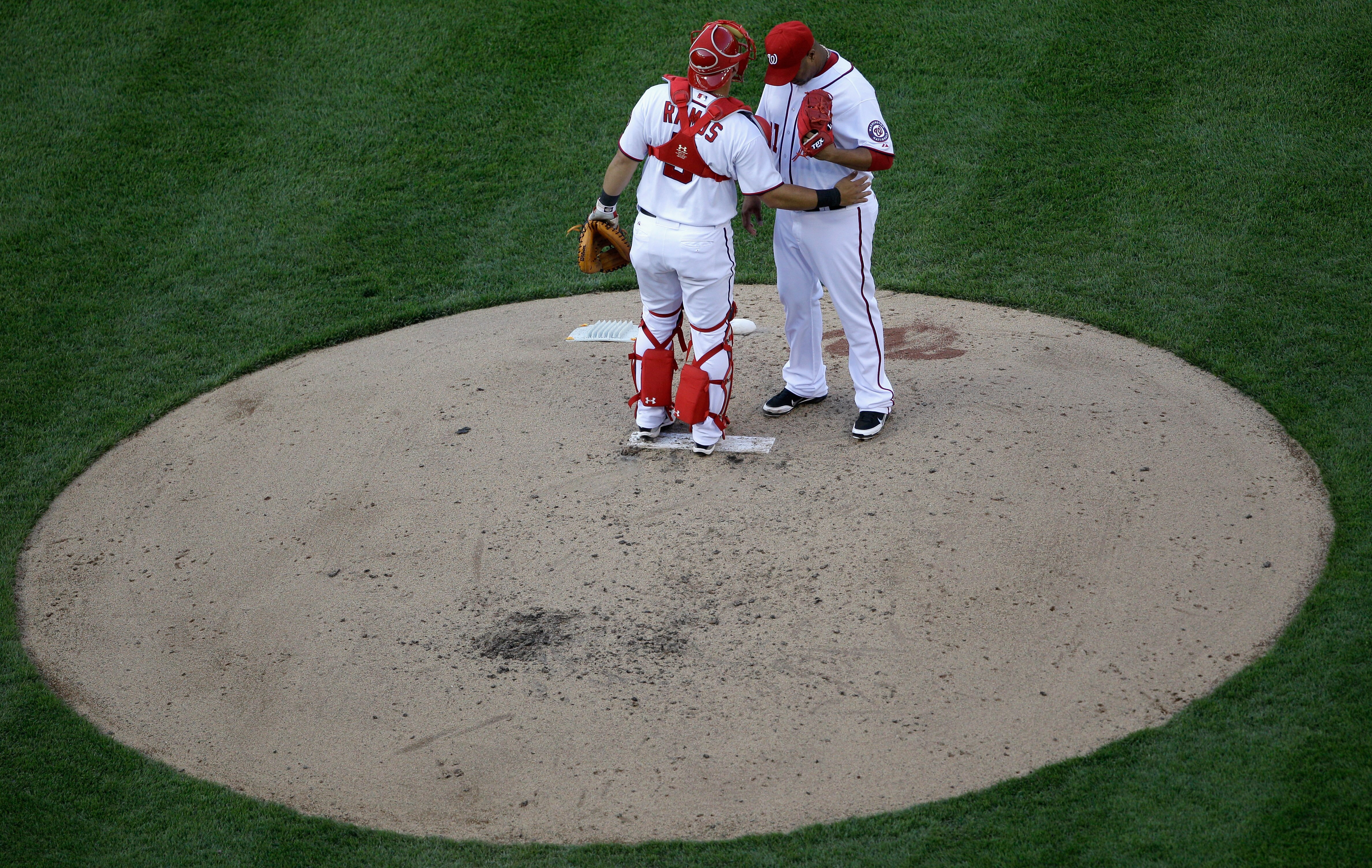 WASHINGTON, DC - APRIL 17:  Catcher Wilson Ramos #3 and pitcher Livan Hernandez #61 of the Washington Nationals talk on the mound during the fourth inning against the Milwaukee Brewers during the second game of a doubleheader at Nationals Park on April 17