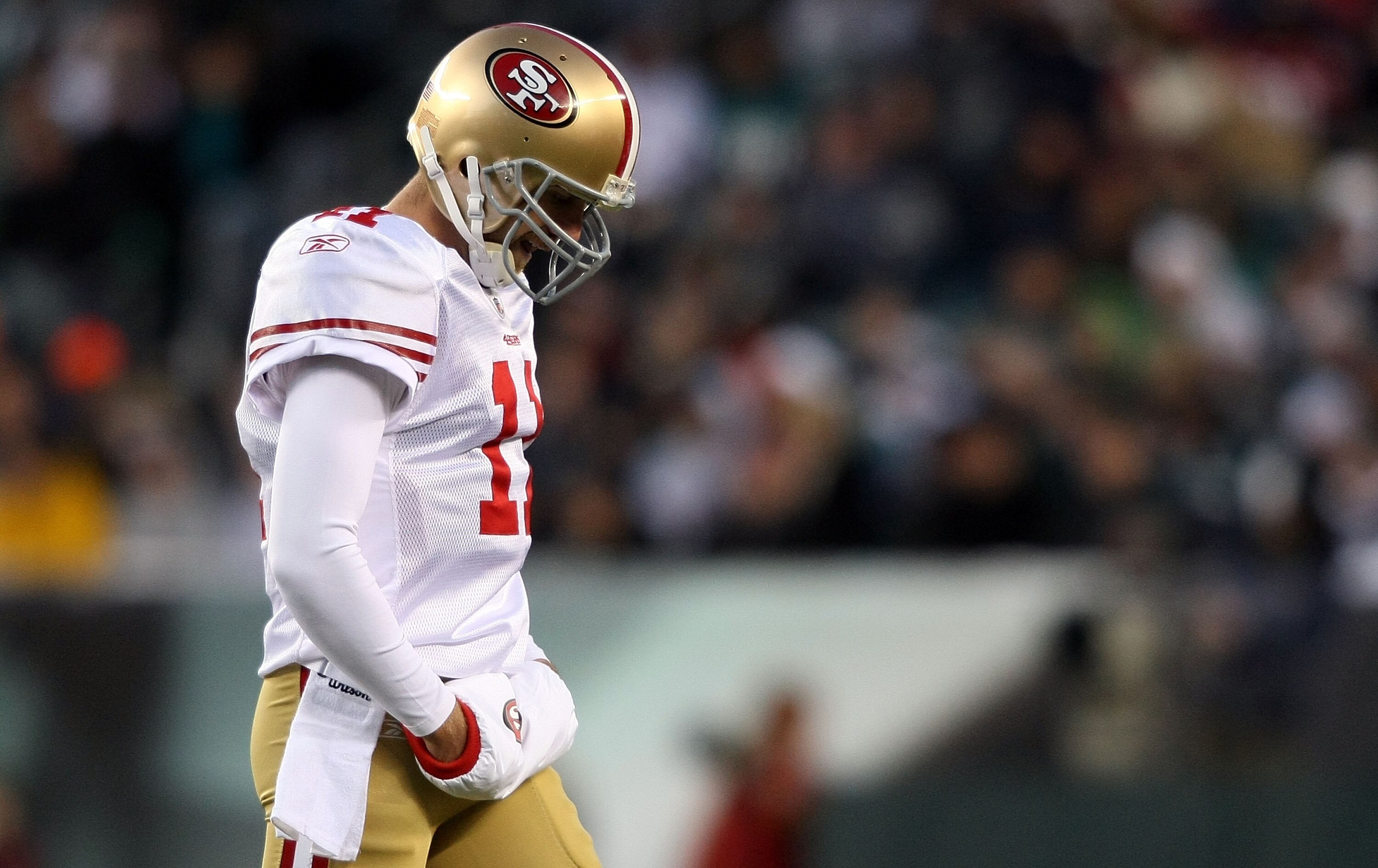 PHILADELPHIA - DECEMBER 20:  Alex Smith #11 of the San Francisco 49ers walks from the field after failing to complete a third down against the Philadelphia Eagles at Lincoln Financial Field on December 20, 2009 in Philadelphia, Pennsylvania.  (Photo by Ni
